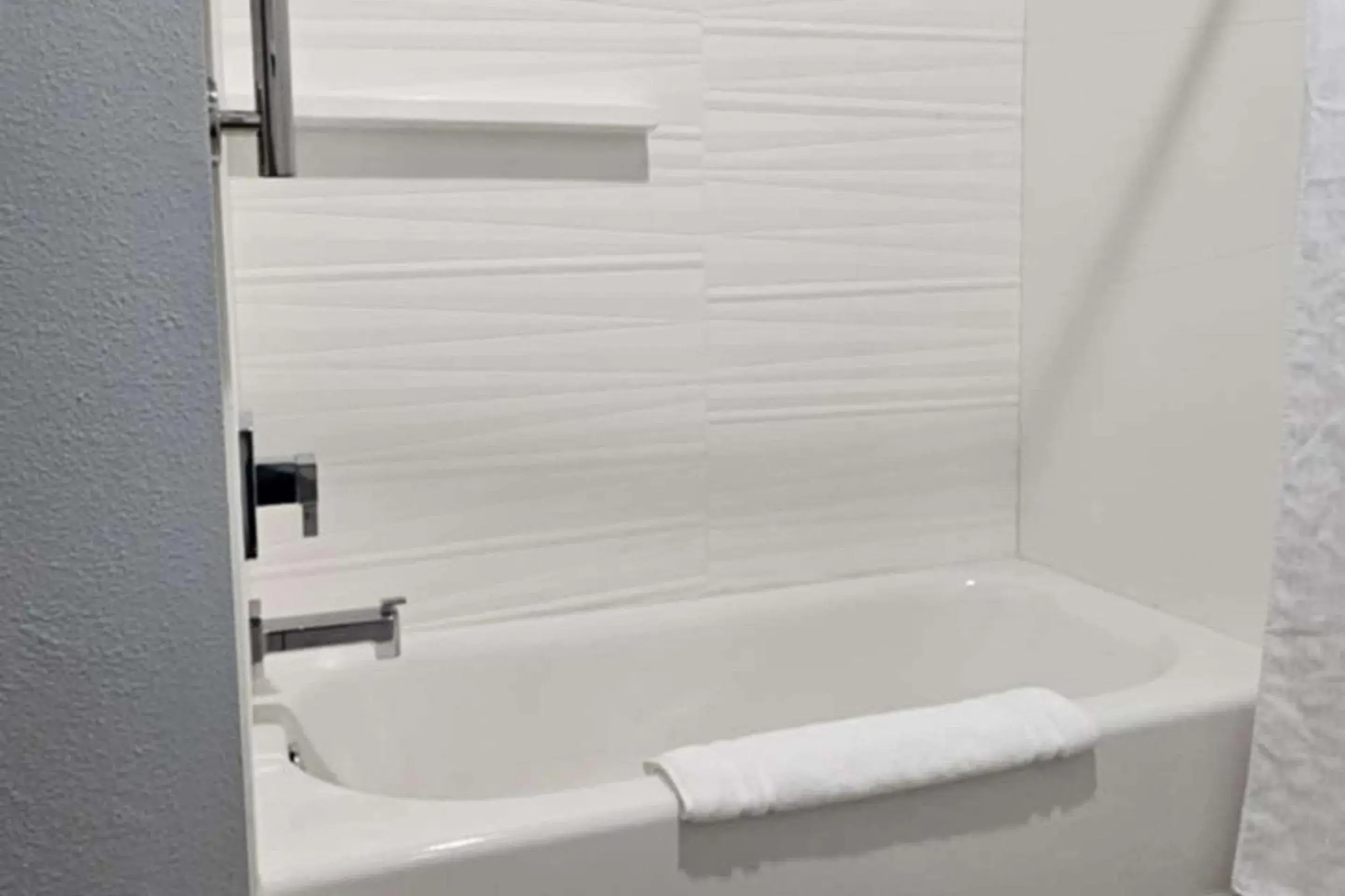 Bedroom in Edgewater Inn and Suites, an Ascend Collection Hotel Bedroom in Edgewater Inn and Suites, an Ascend Collection Hotel