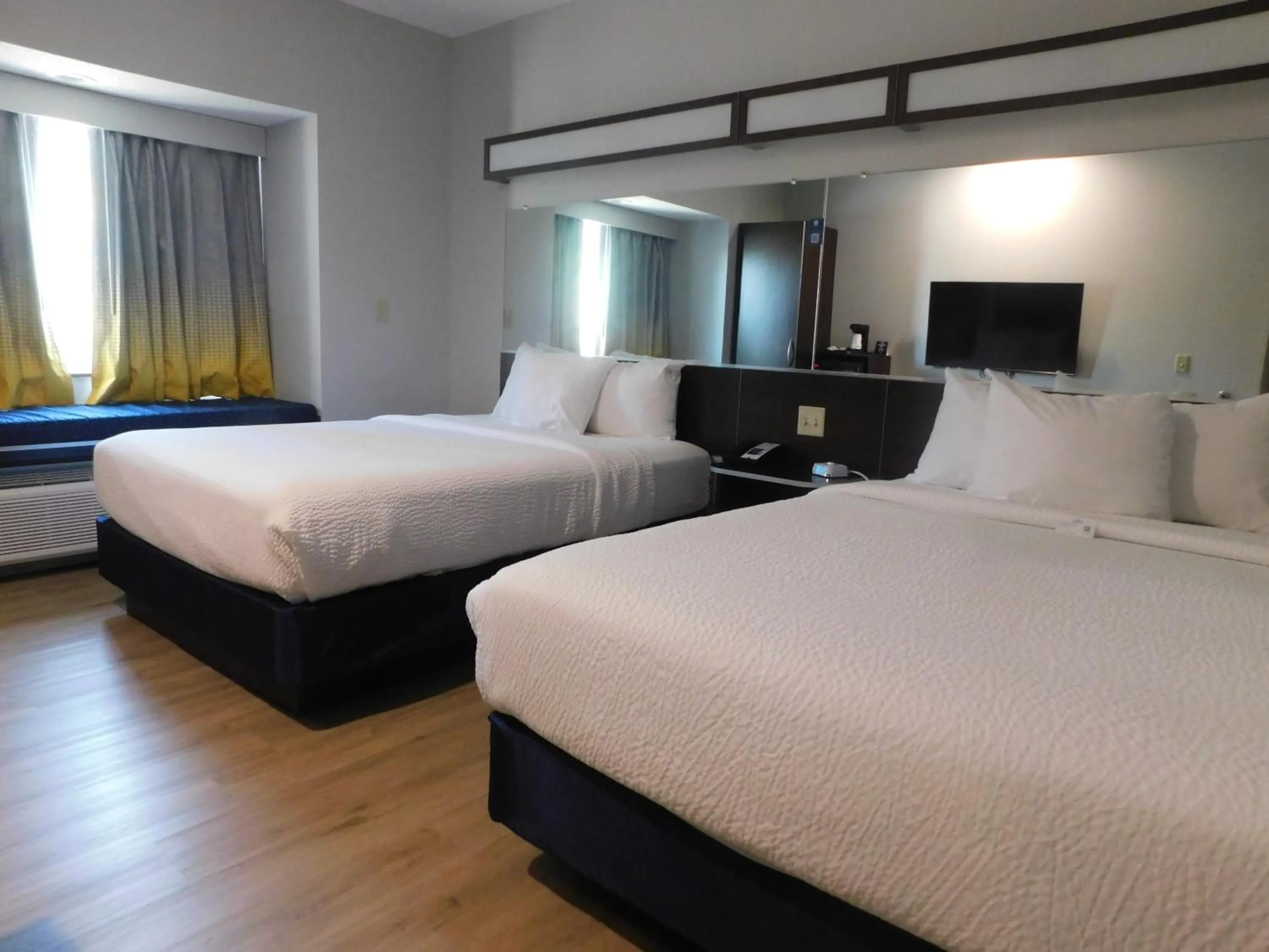 Bed in Microtel Inn & Suites by Wyndham Wheeling at The Highlands