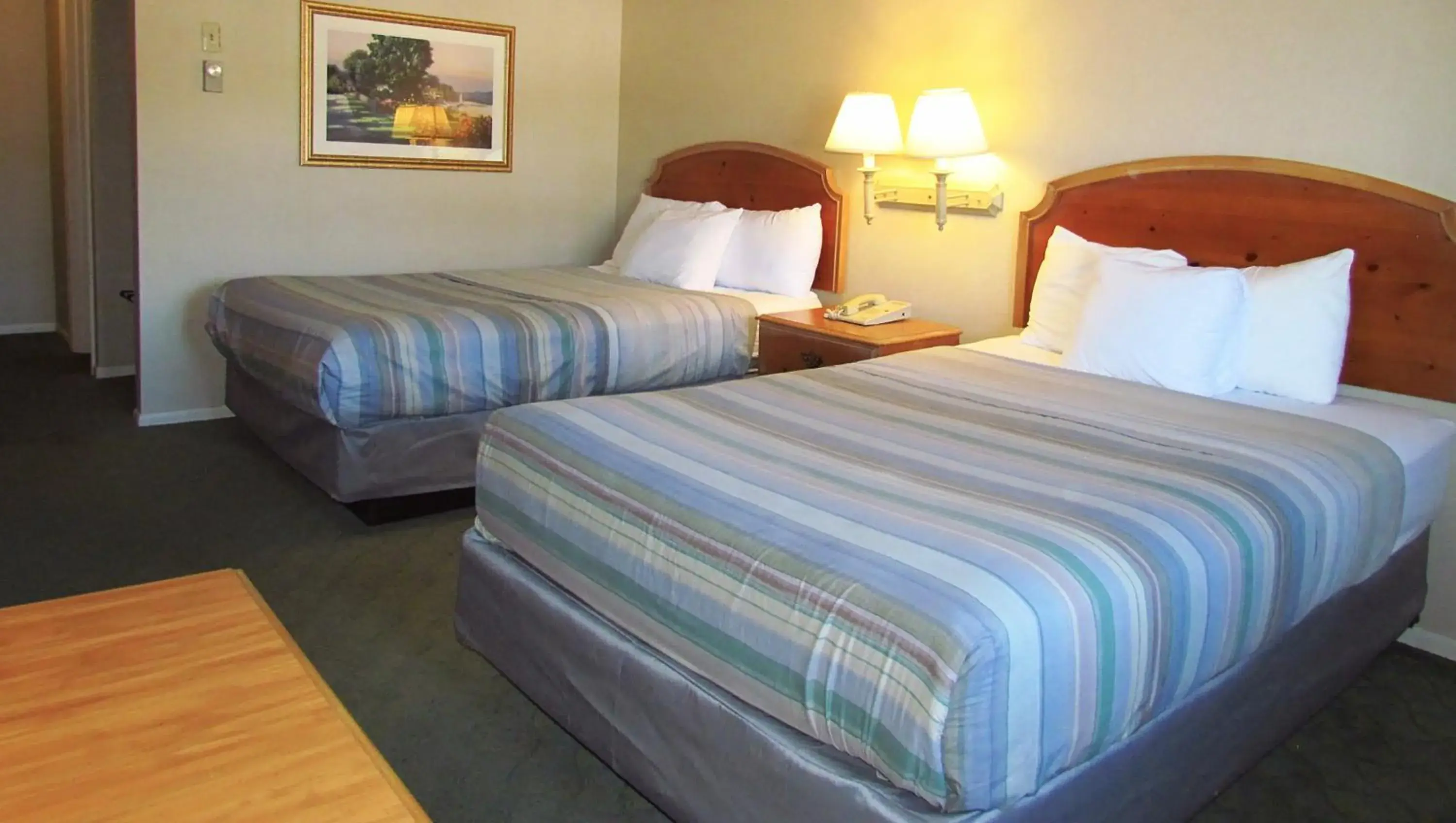 Bedroom, Bed in Magnuson Grand Pioneer Inn and Suites Bedroom, Bed in Magnuson Grand Pioneer Inn and Suites