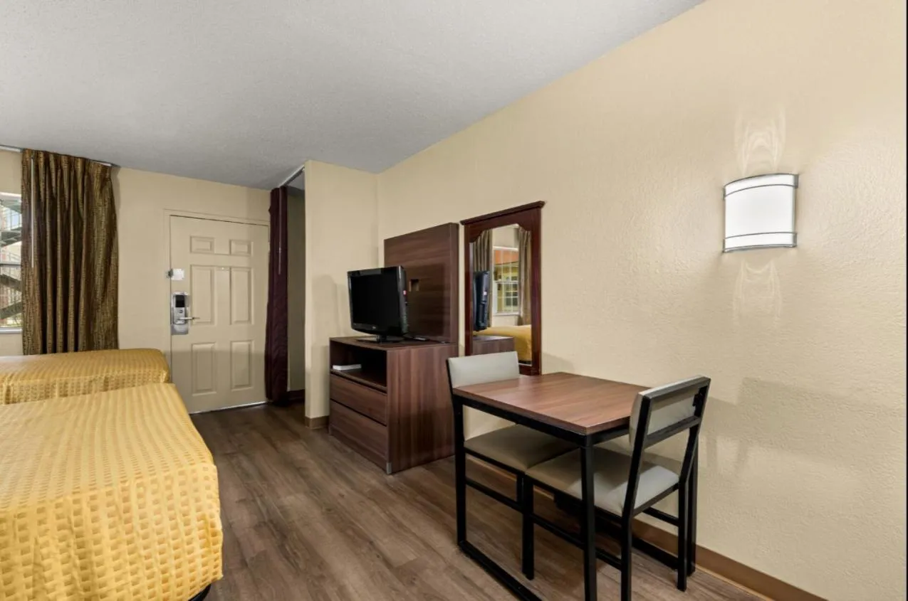 Seating area, Bed in Suburban Studios Winston-Salem near Hanes Mall