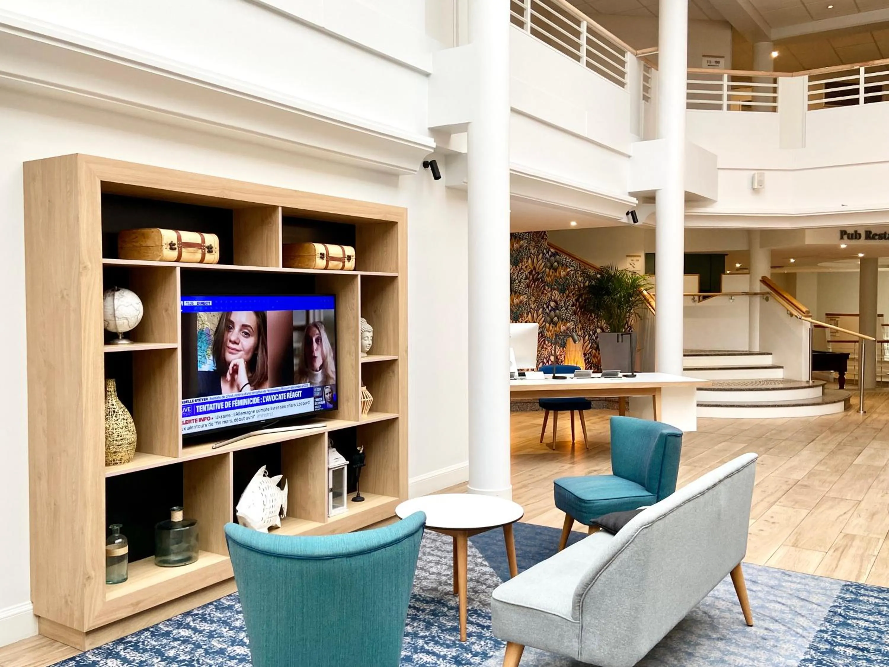 Communal lounge/ TV room in Holiday Inn Calais Coquelles by IHG