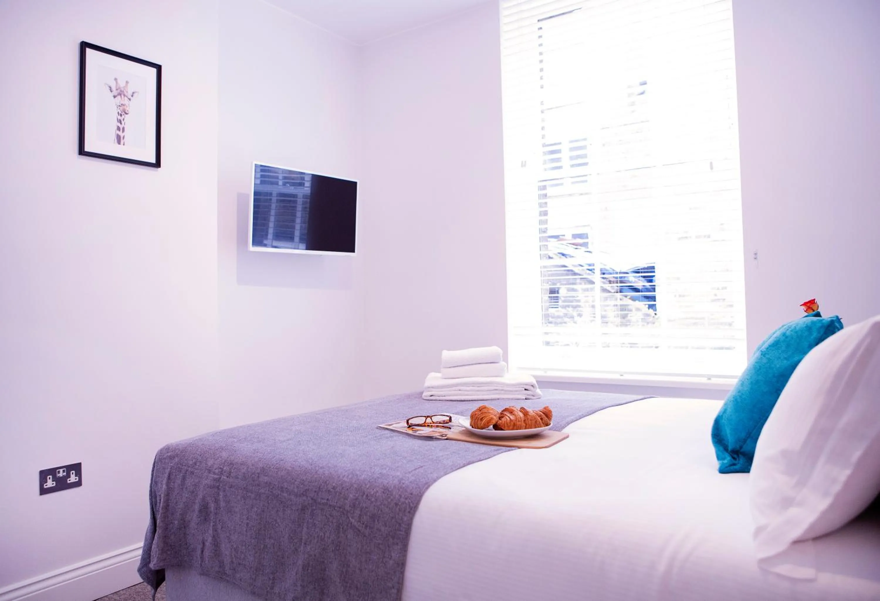 Bed in Quiet Central West End Apartments by Indigo Flats
