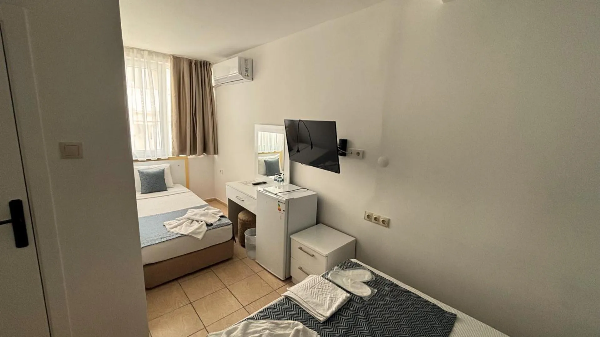 Bed in MOONBOW BEACH HOTEL