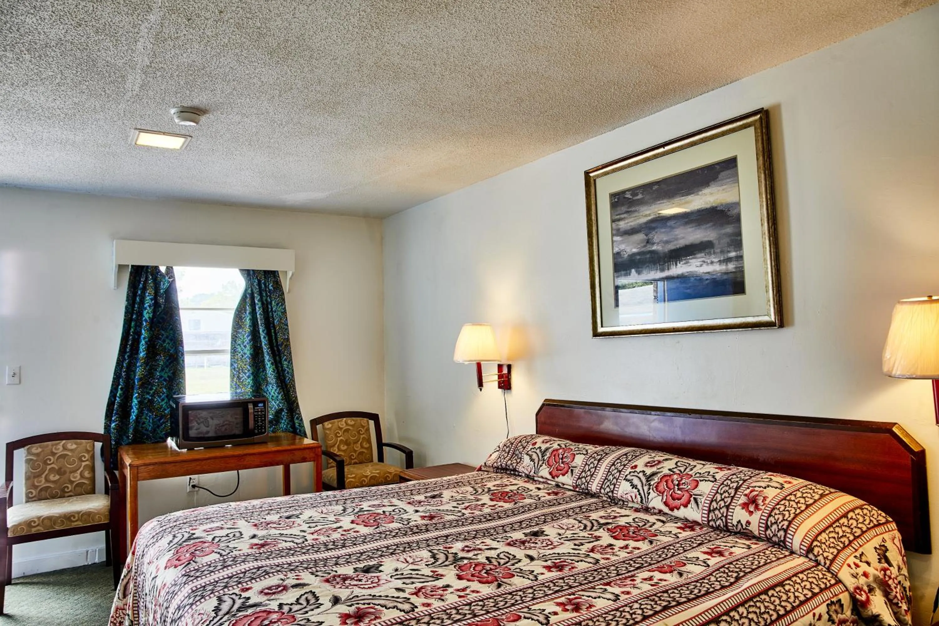 Bedroom in Hospitality Inn