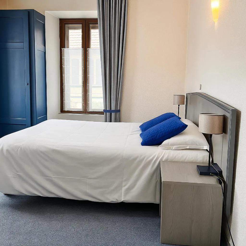 Bed in Logis Hôtel de Genève et Restaurant , Faverges-Seythenex