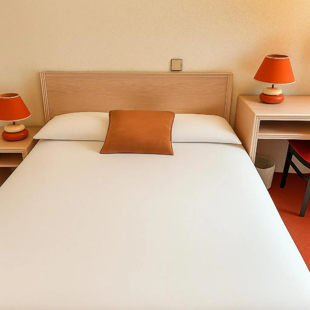 Bed in Logis Hôtel de Genève et Restaurant , Faverges-Seythenex