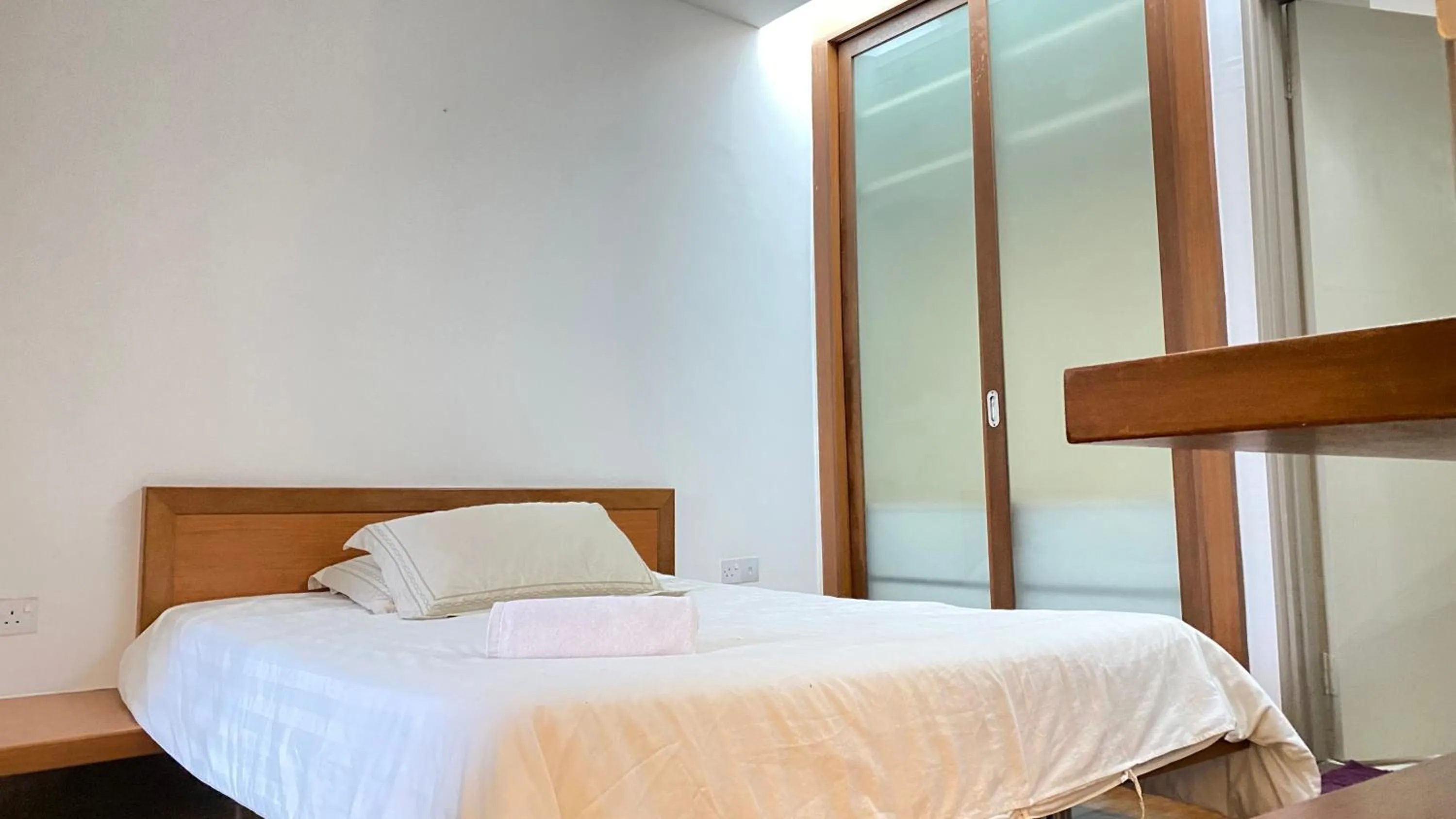 Bed in Peninsula Residence All Suite Hotel