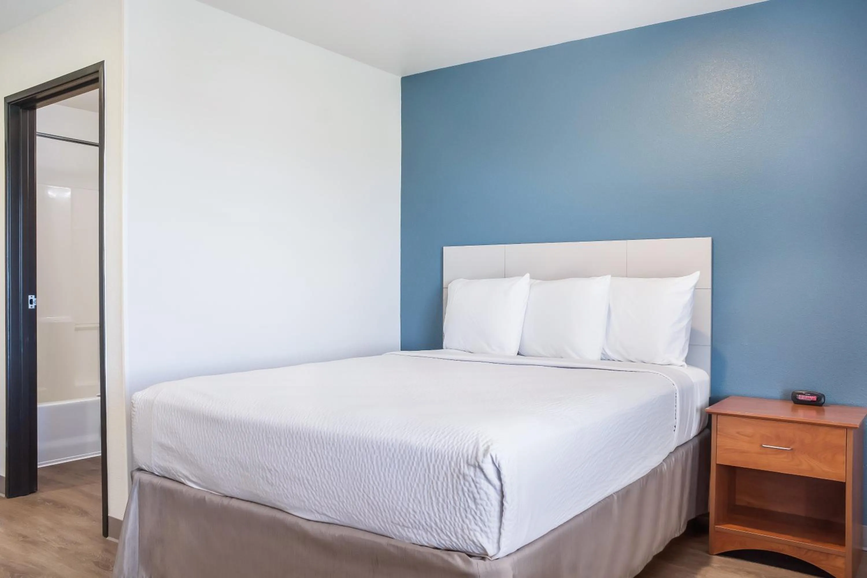 Bed in WoodSpring Suites Conroe