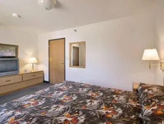 Bed in Northwoods Inn and Suites