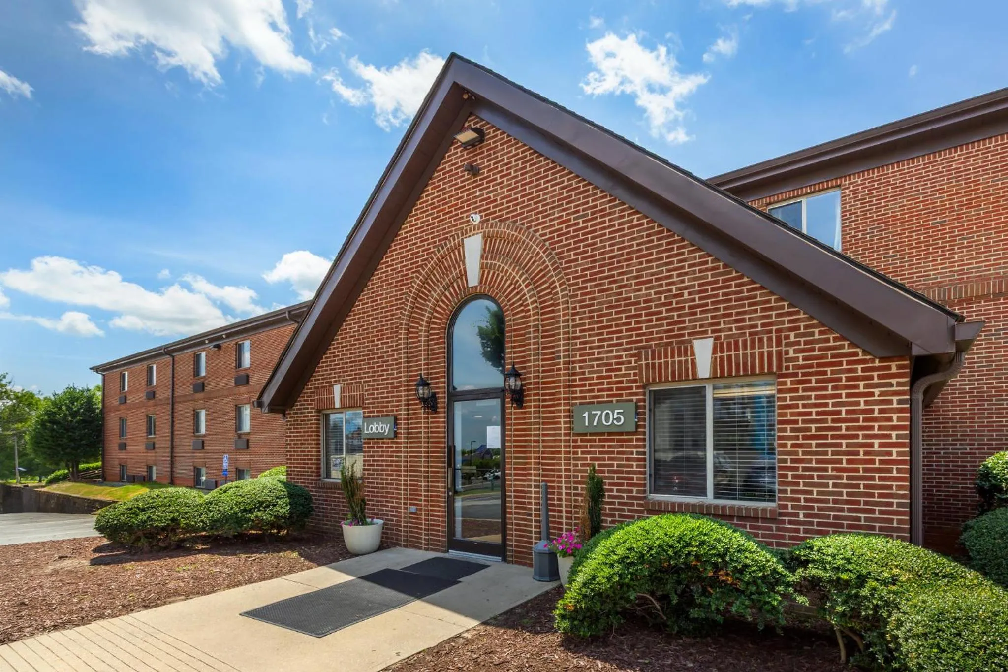 Property building in HomeTowne Studios & Suites by Red Roof Greensboro