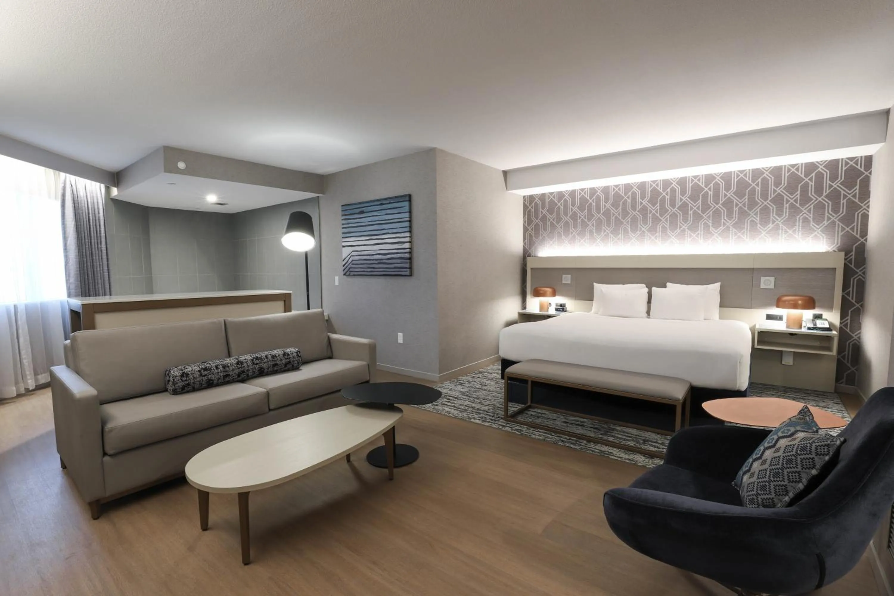 Living room, Bed in Radisson Plaza Hotel at Kalamazoo Center