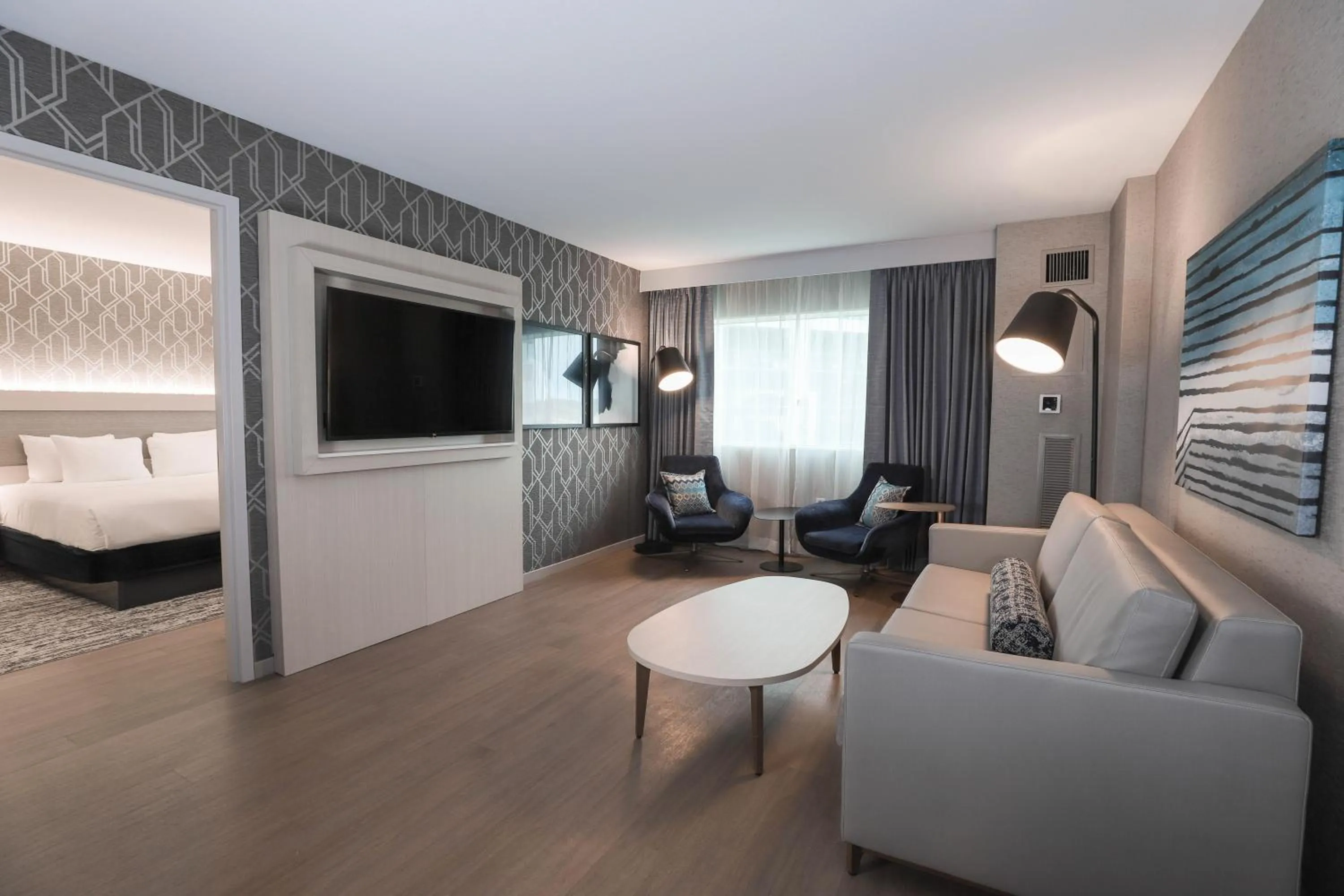 Living room, Bed in Radisson Plaza Hotel at Kalamazoo Center