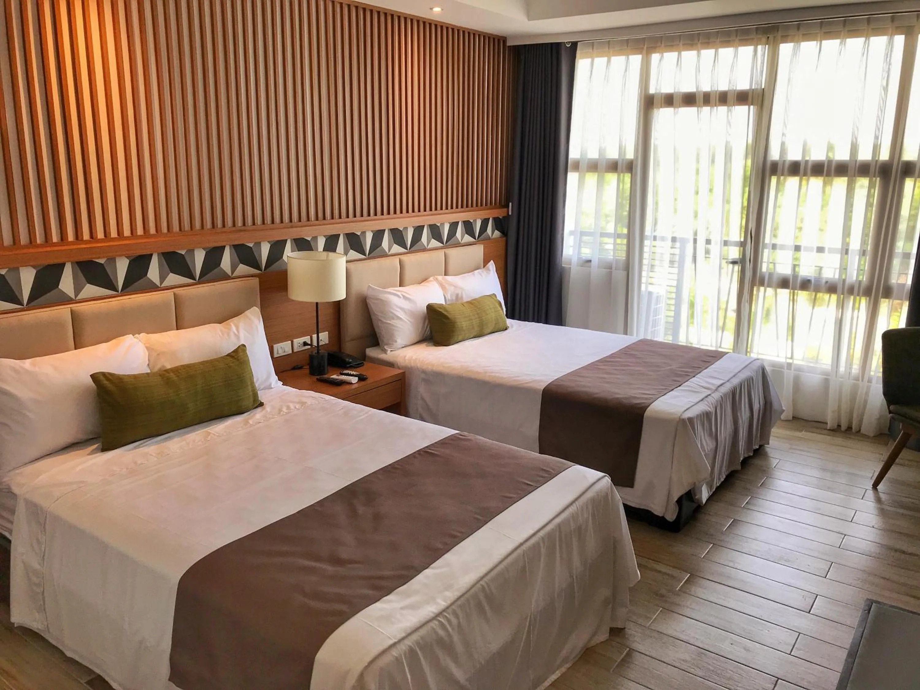 Photo of the whole room, Bed in Crown Hotel at Harbour Springs Palawan Managed by Enderun Hotels