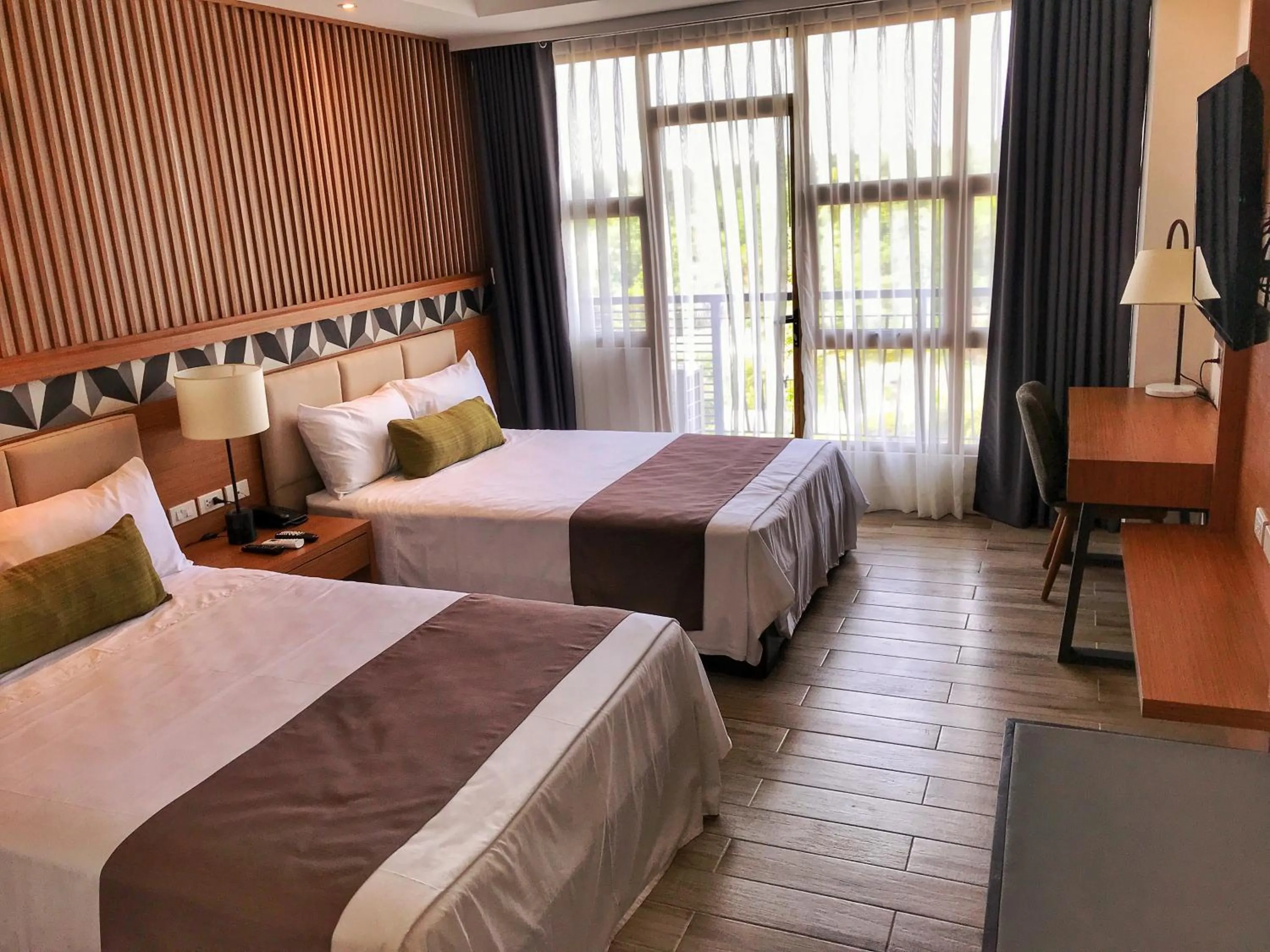 Photo of the whole room, Bed in Crown Hotel at Harbour Springs Palawan Managed by Enderun Hotels