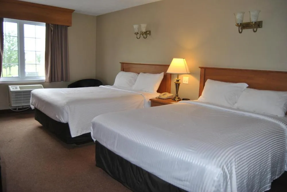 Bed in Auberge Bouctouche Inn & Suites