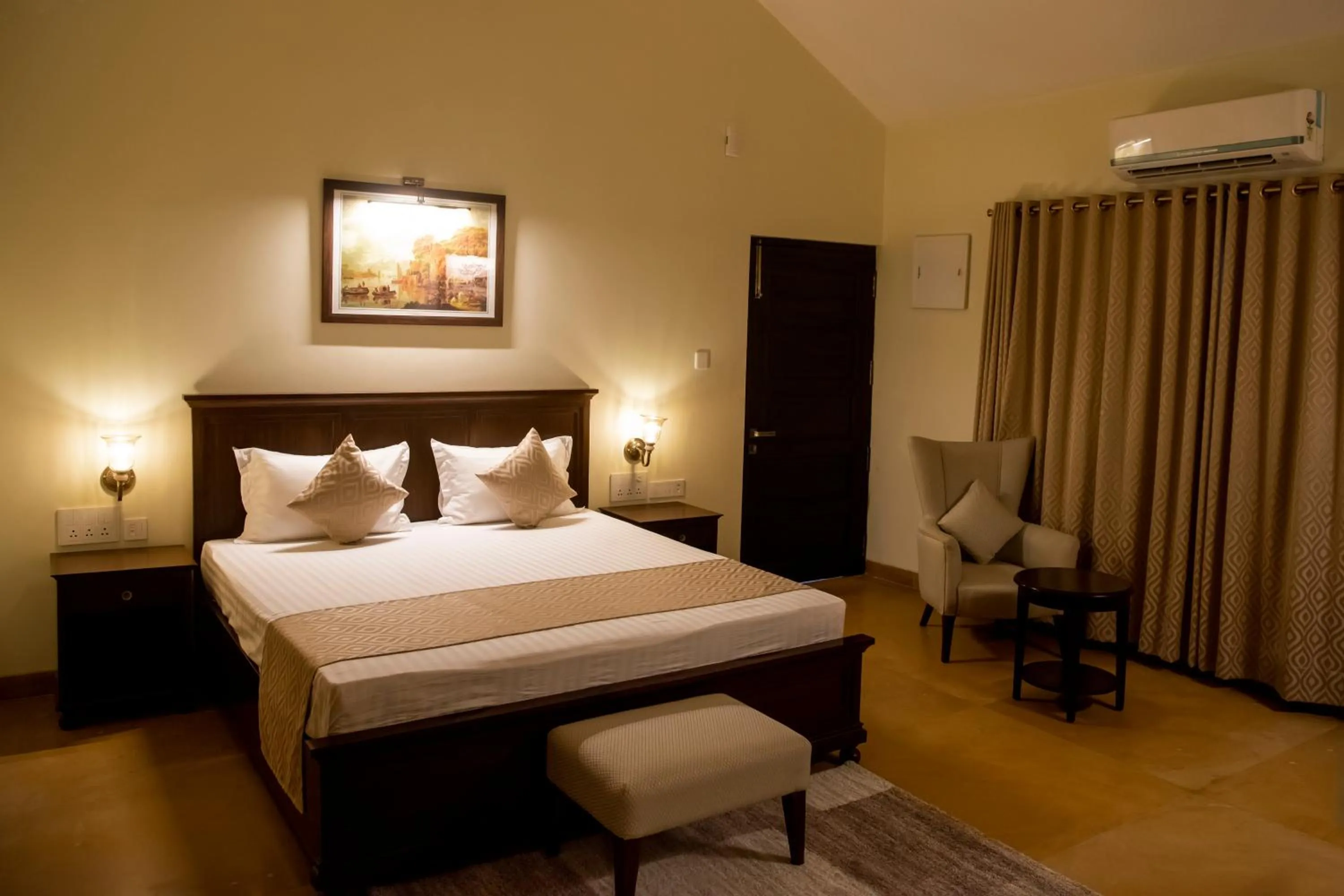 Bed in WelcomHeritage Tadoba Vanya Villas Resort & Spa