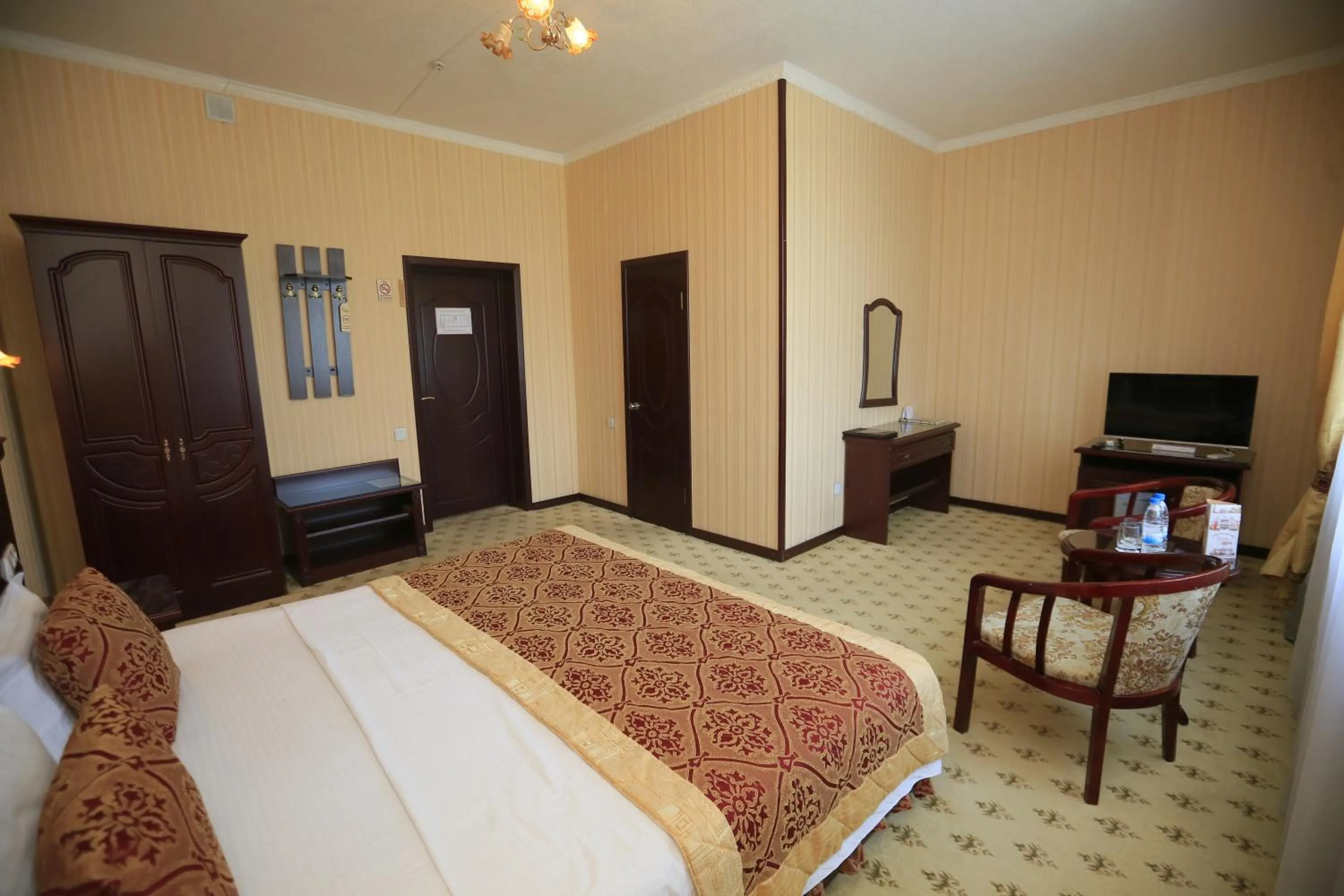 Communal lounge/ TV room, Bed in Asia Hotel Fergana