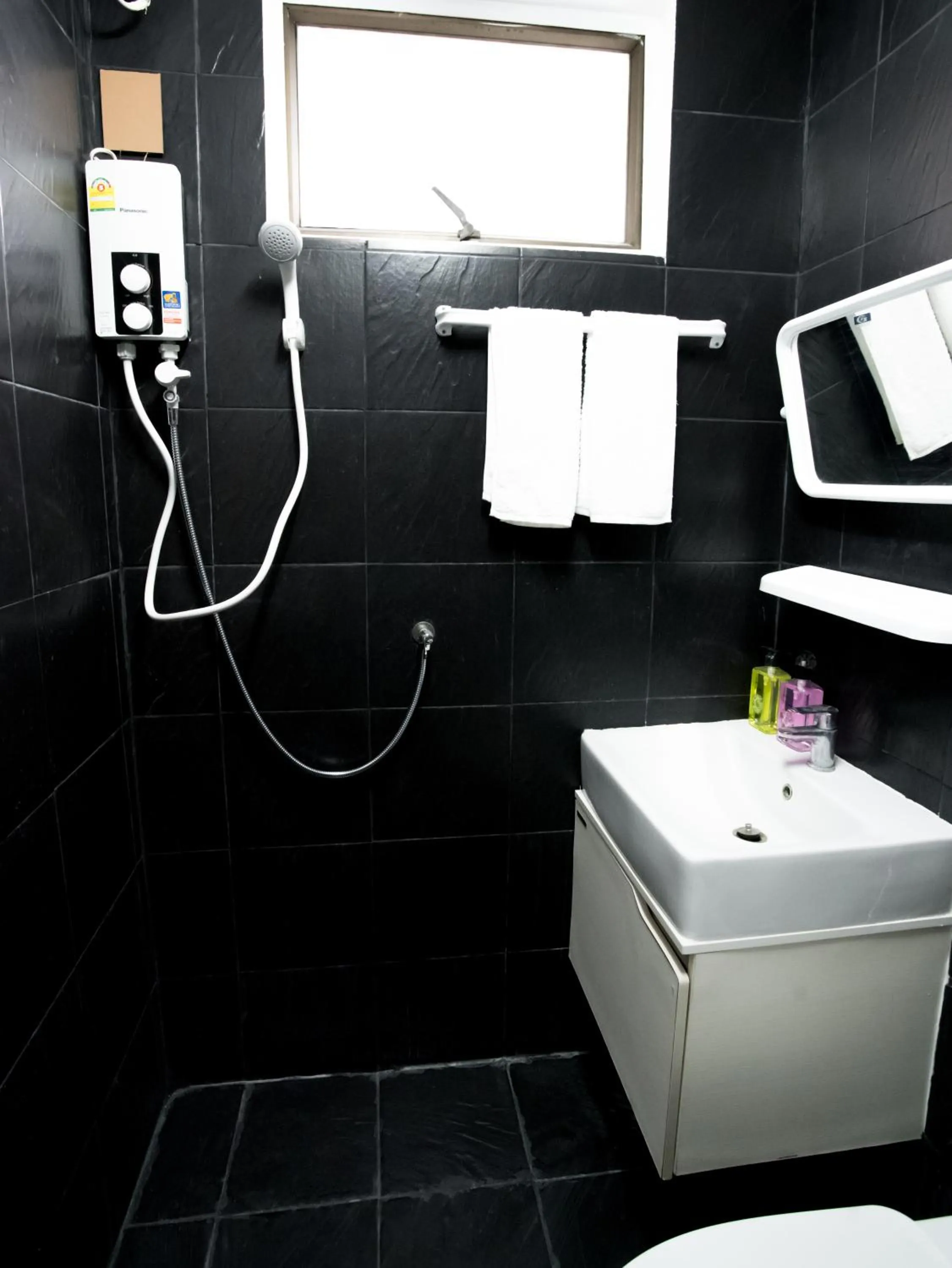 Bathroom in RoomQuest Bangkok Ratchada