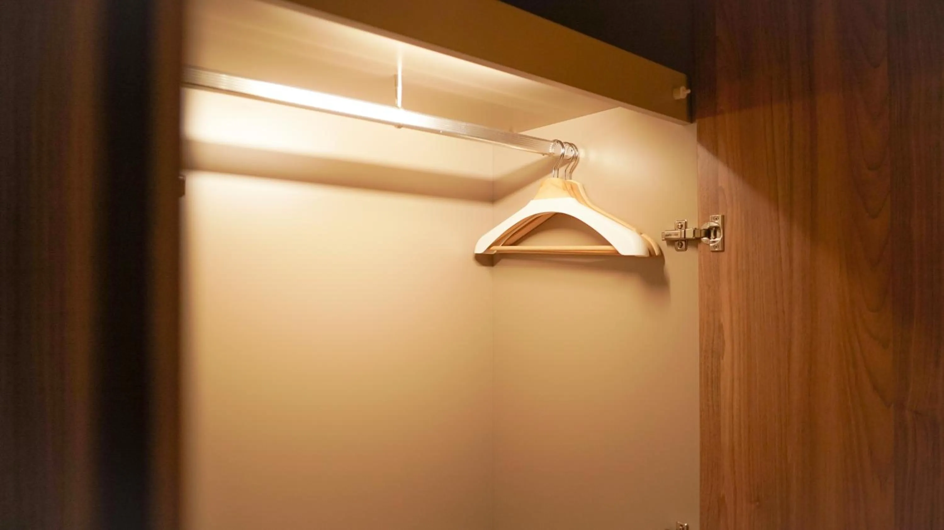 wardrobe in Nagomi Suites & Hotel