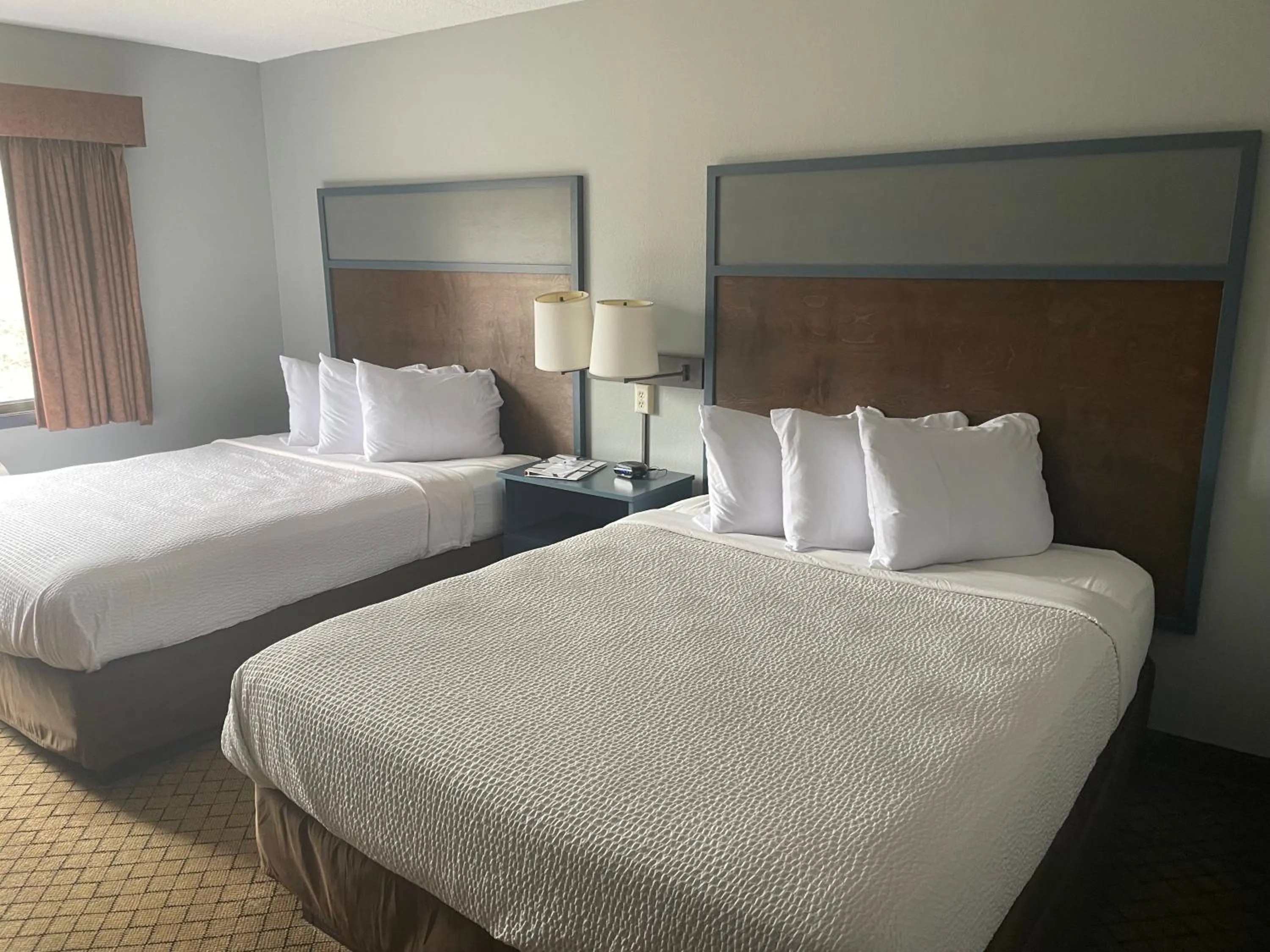 Bed in AmericInn by Wyndham Hartford WI