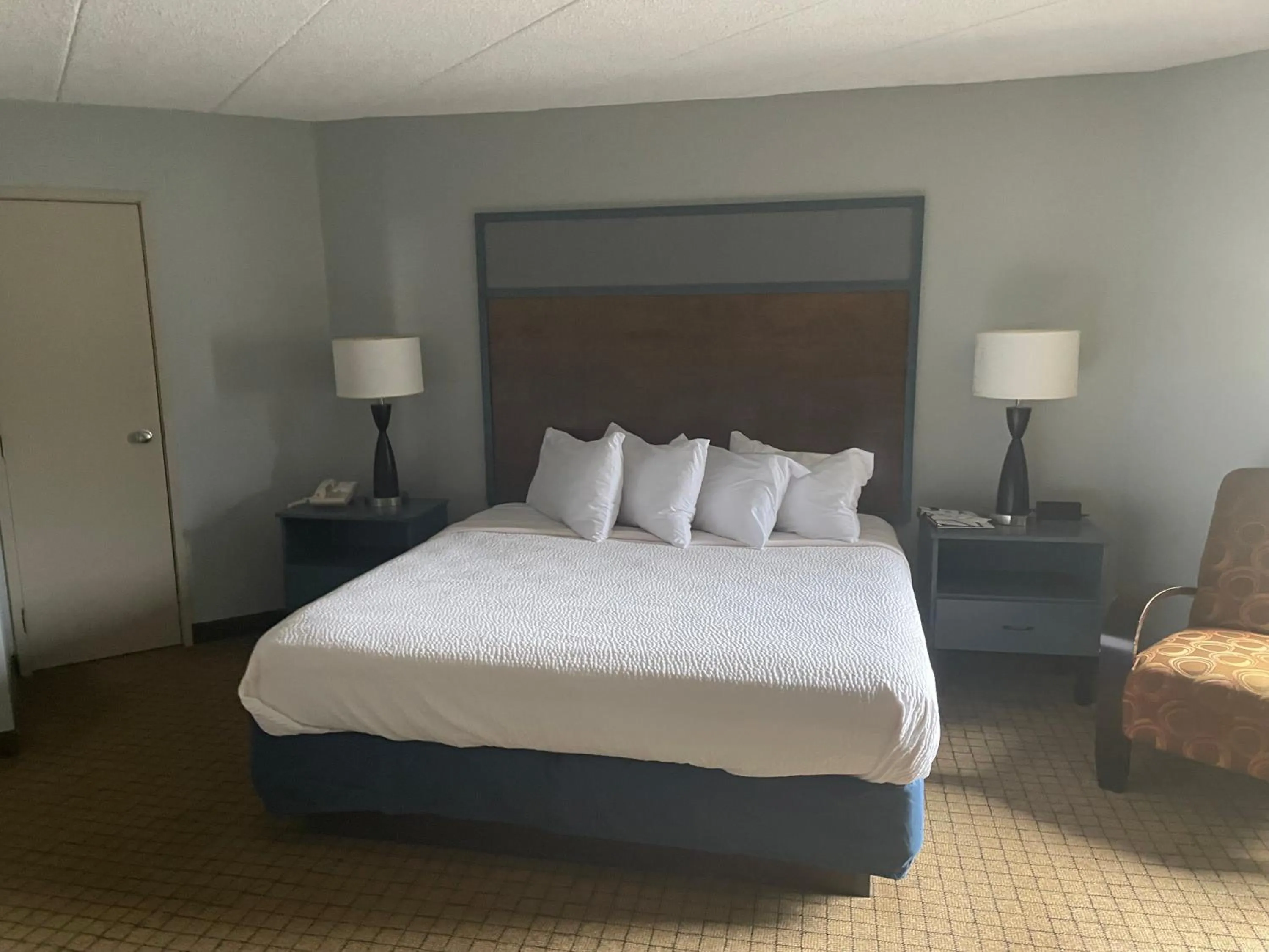 Bed in AmericInn by Wyndham Hartford WI