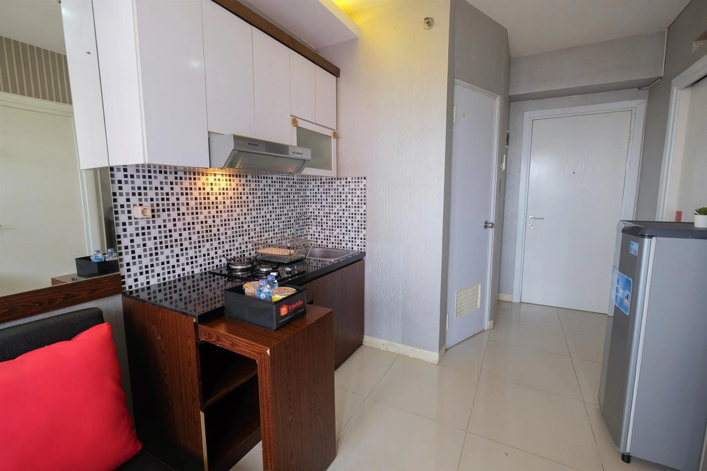 Homey and Relaxing 2BR Green Pramuka City Apartment By Travelio