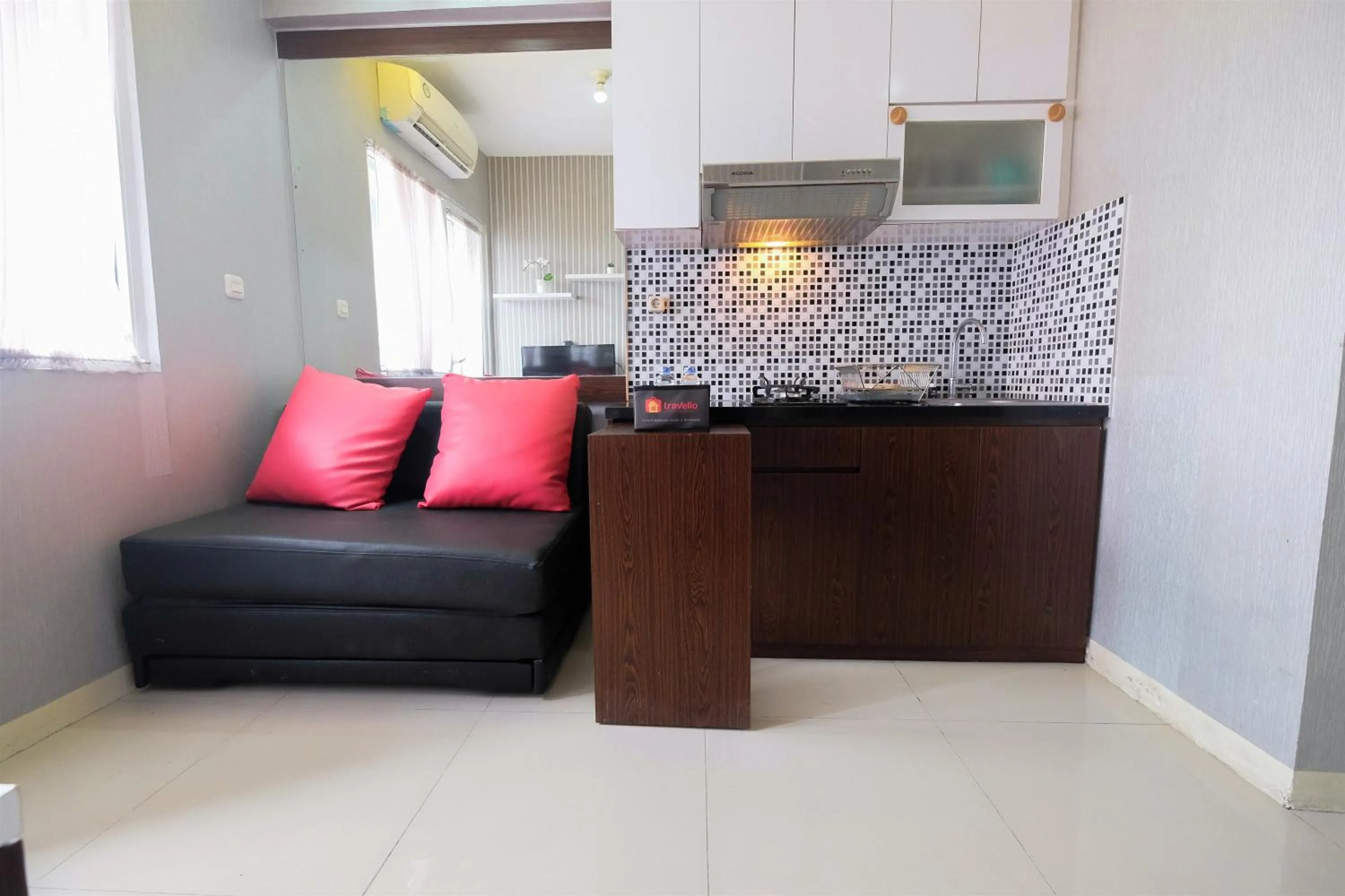 Homey and Relaxing 2BR Green Pramuka City Apartment By Travelio