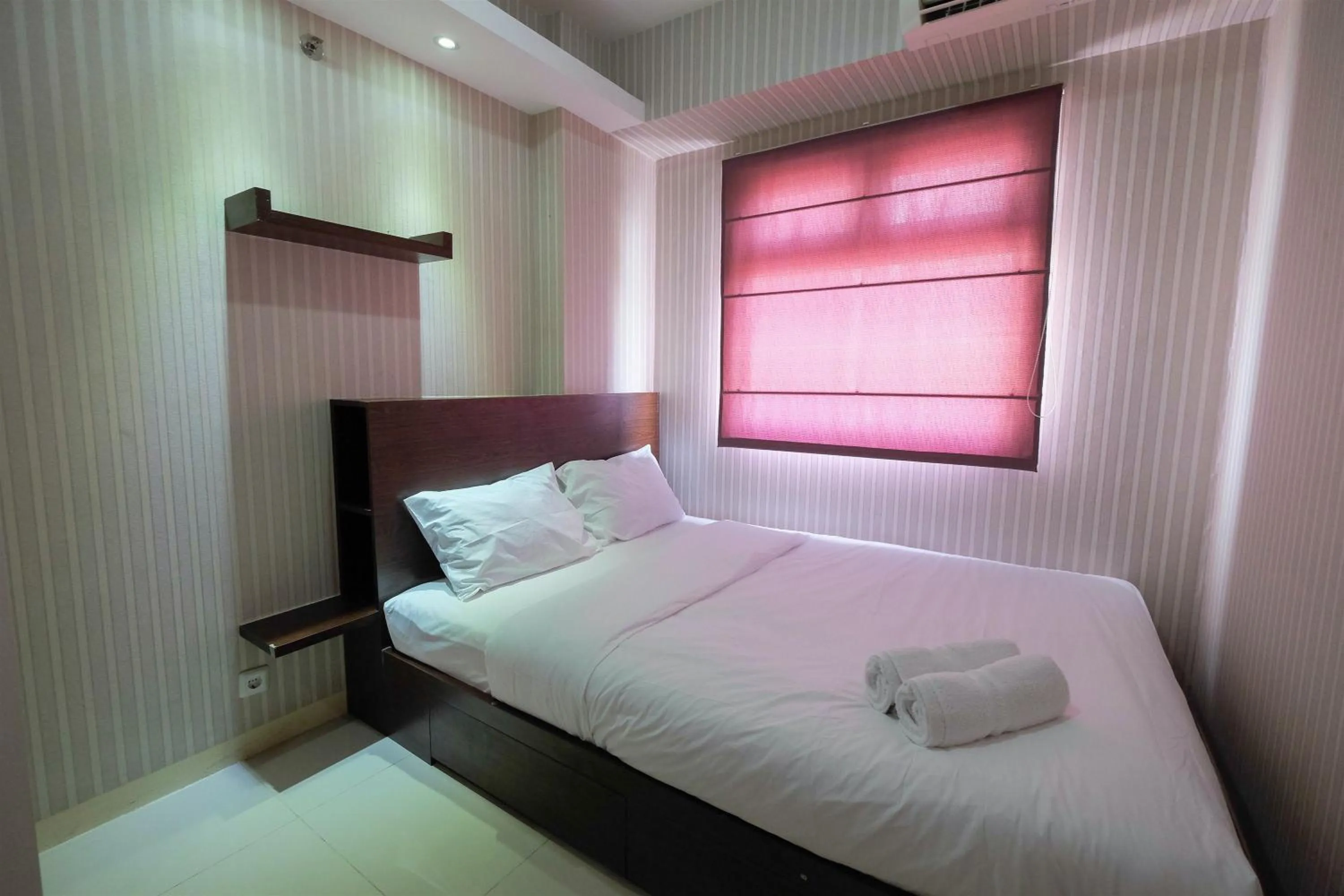Bed in Homey and Relaxing 2BR Green Pramuka City Apartment By Travelio