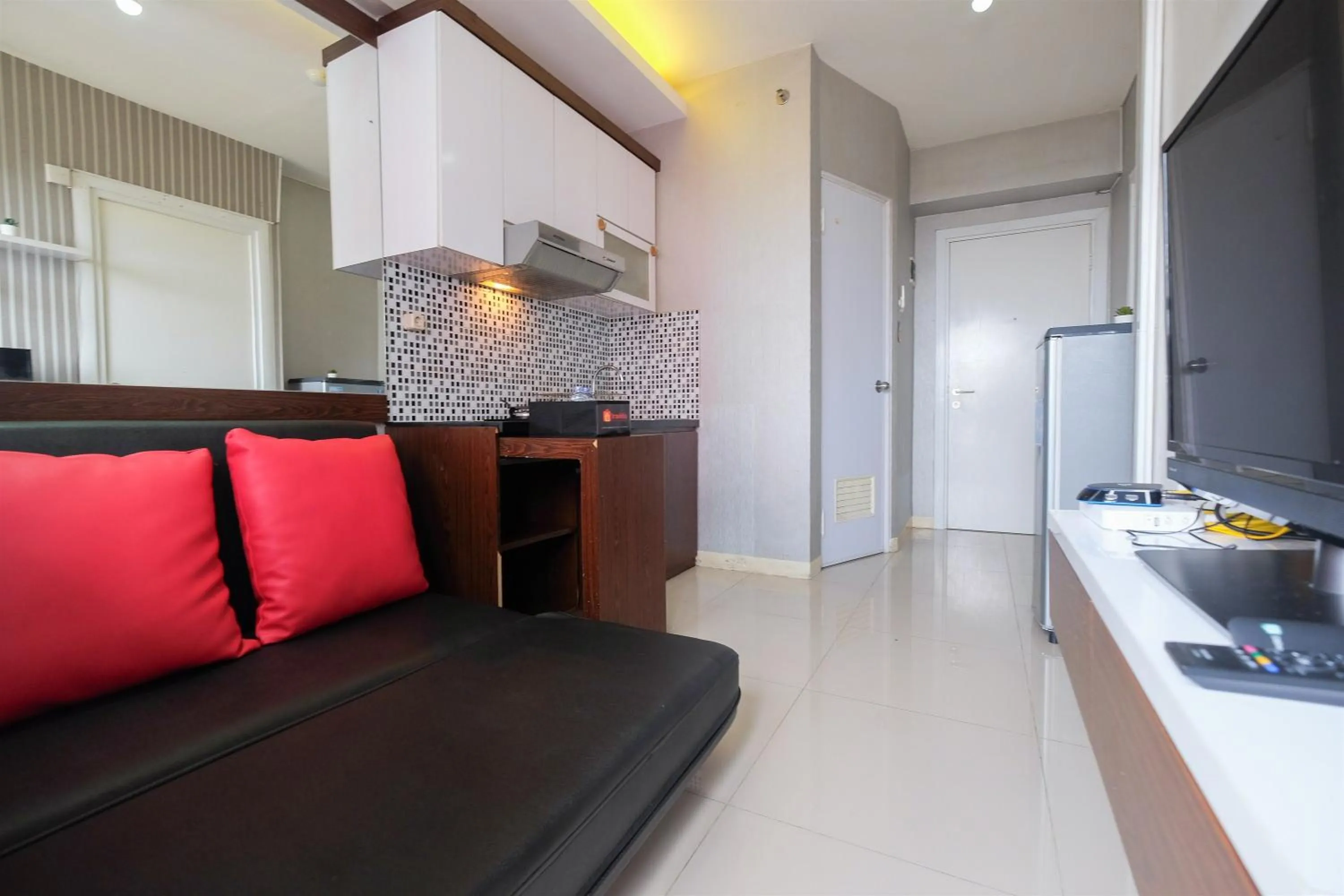 Homey and Relaxing 2BR Green Pramuka City Apartment By Travelio
