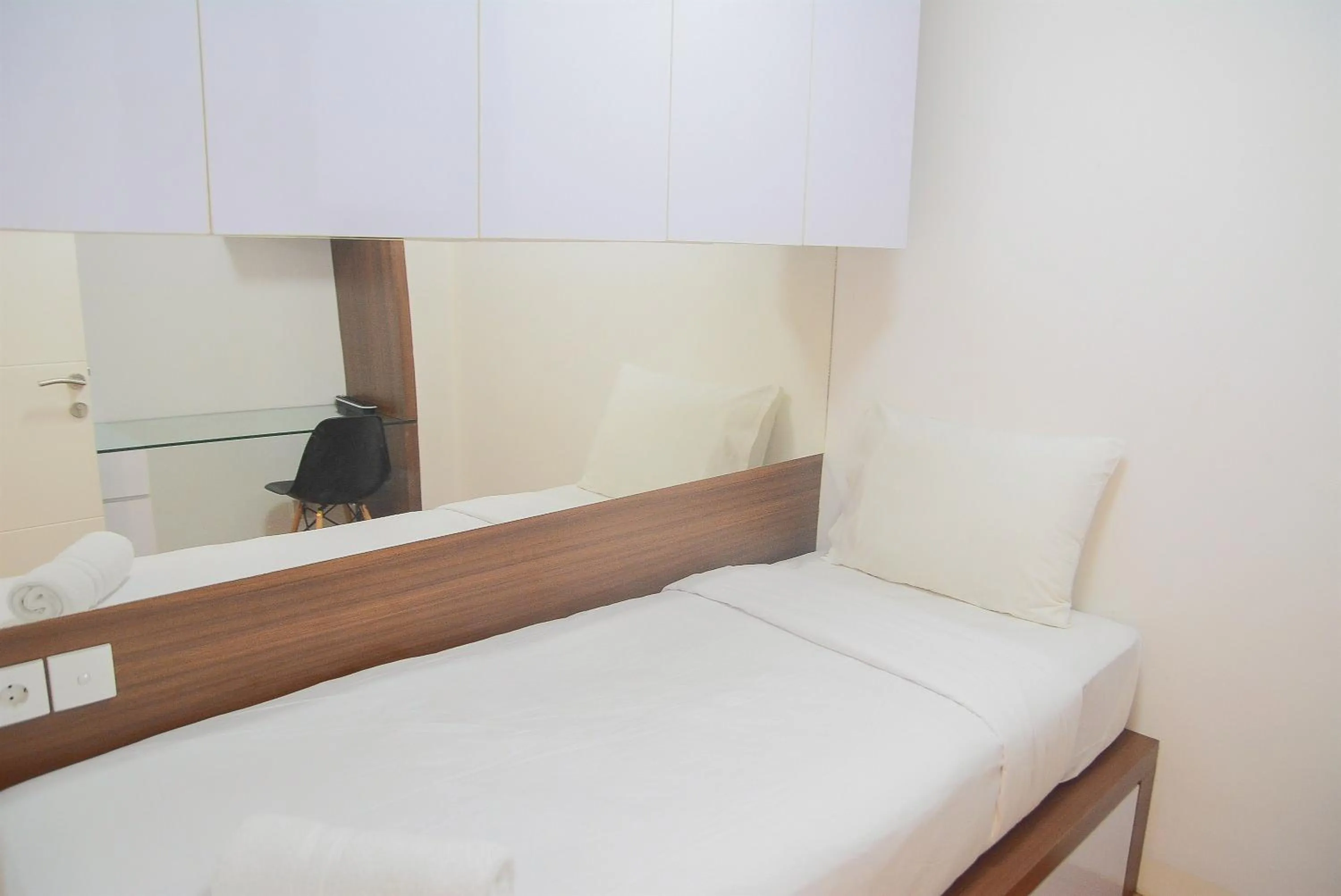 Pool View 2BR with Sofa Bed Bassura City Apartment By Travelio