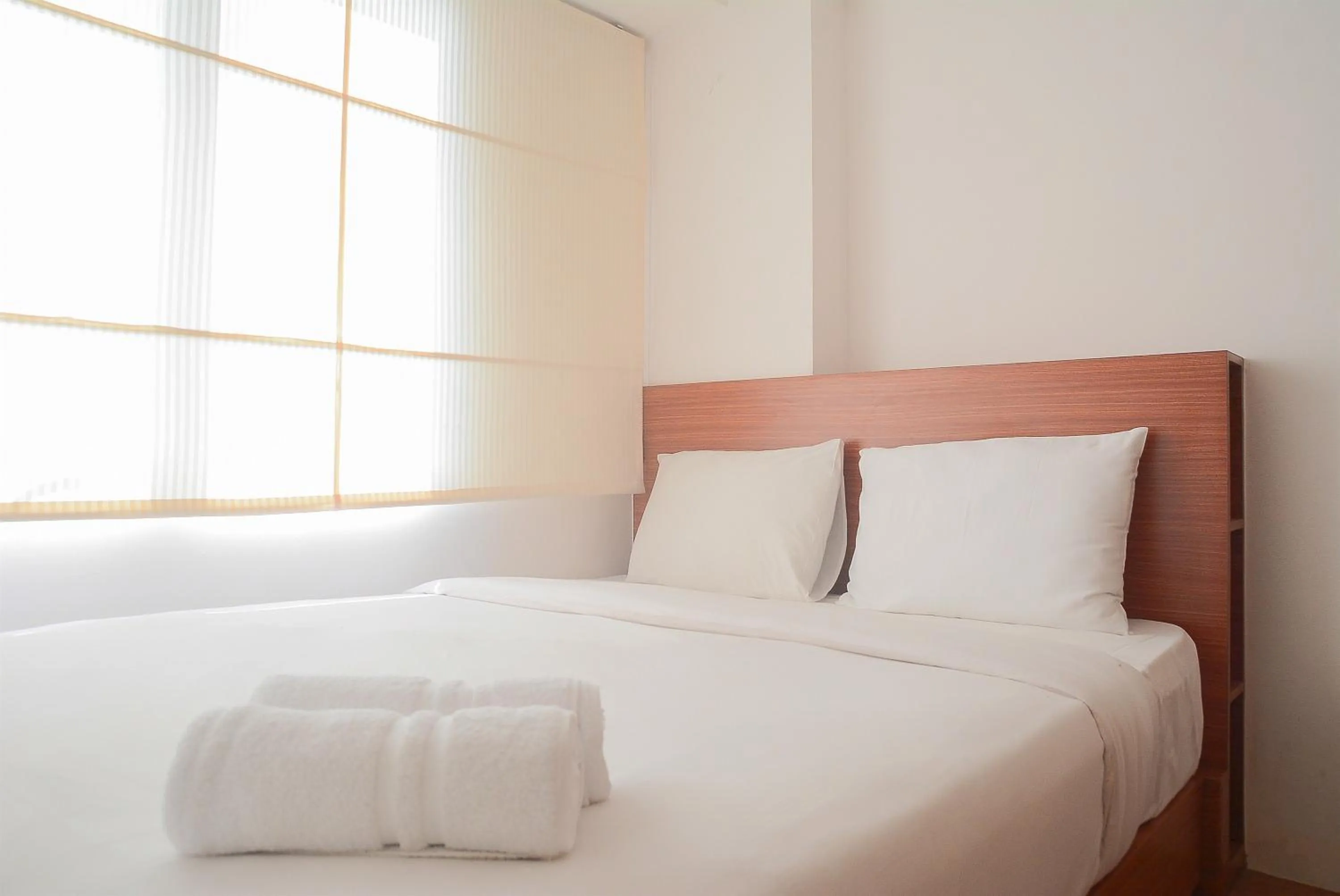 Pool View 2BR with Sofa Bed Bassura City Apartment By Travelio