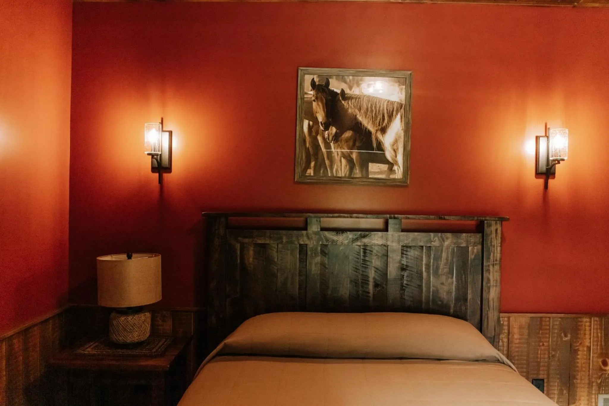 Bed in Sojourner's Lodge & Log Cabin Suites