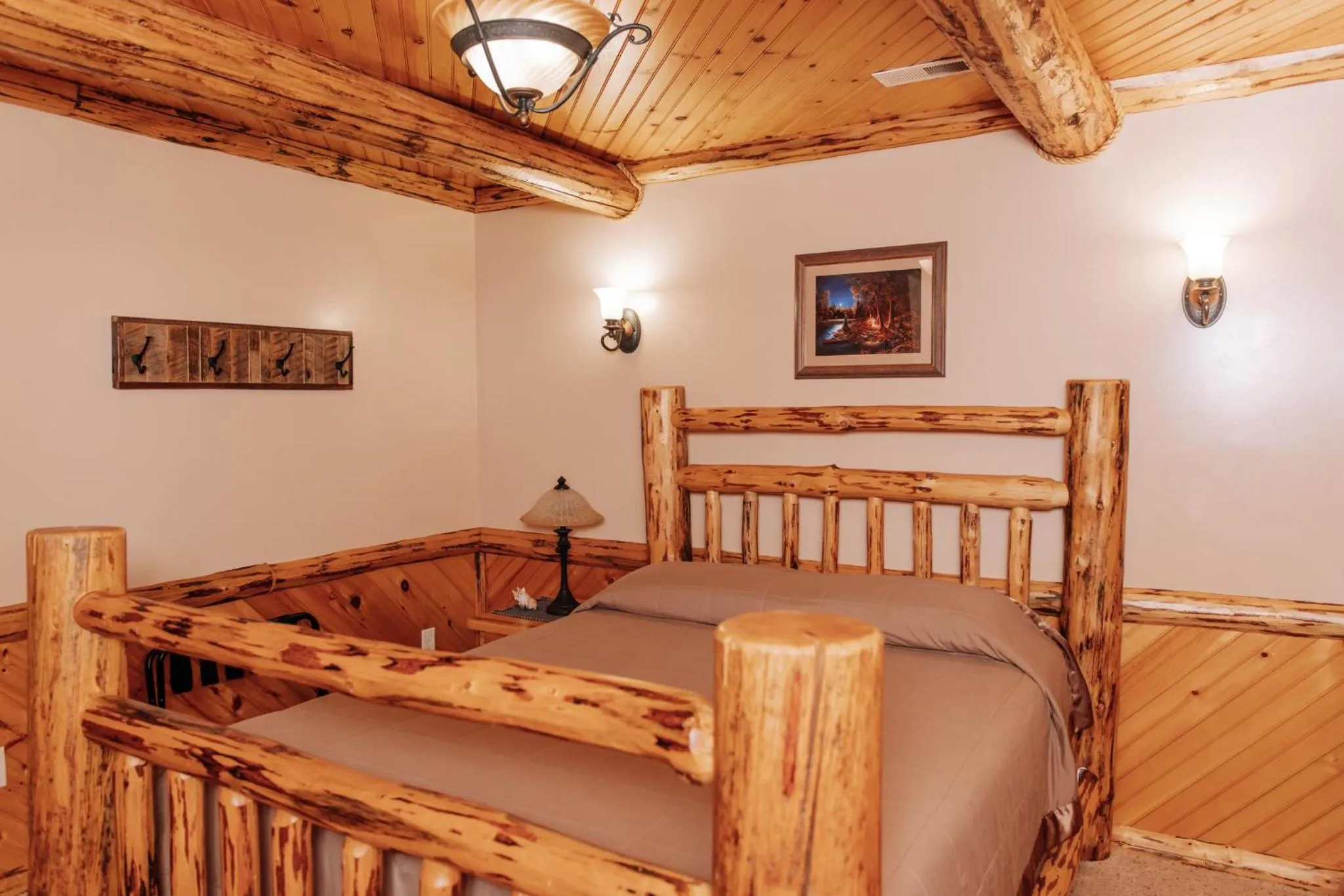 Bed in Sojourner's Lodge & Log Cabin Suites