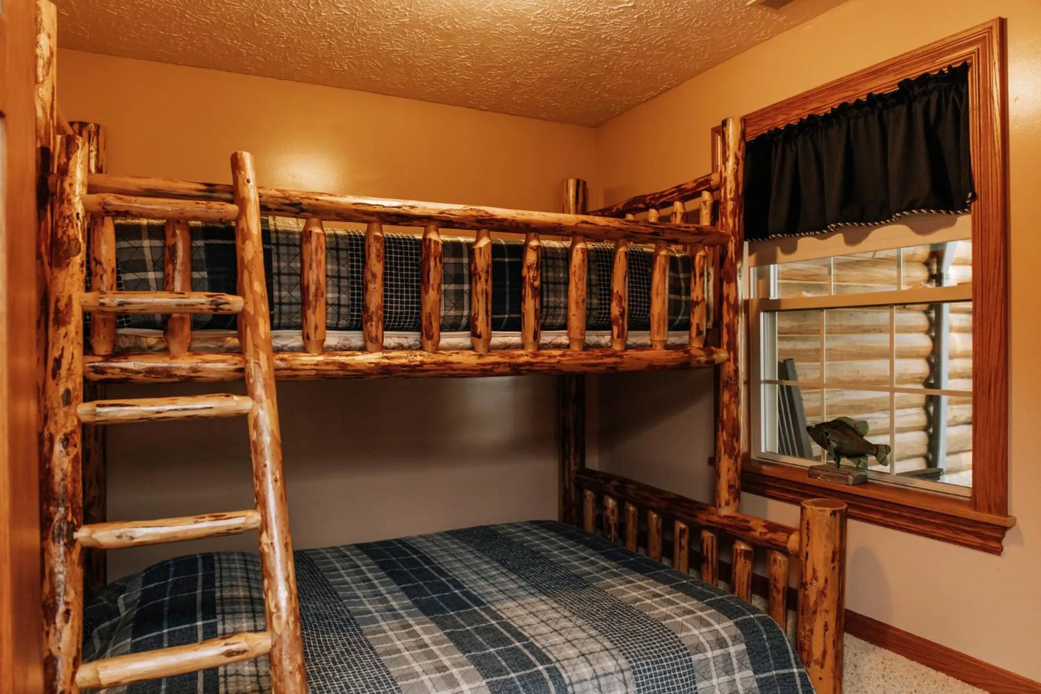 Bed in Sojourner's Lodge & Log Cabin Suites