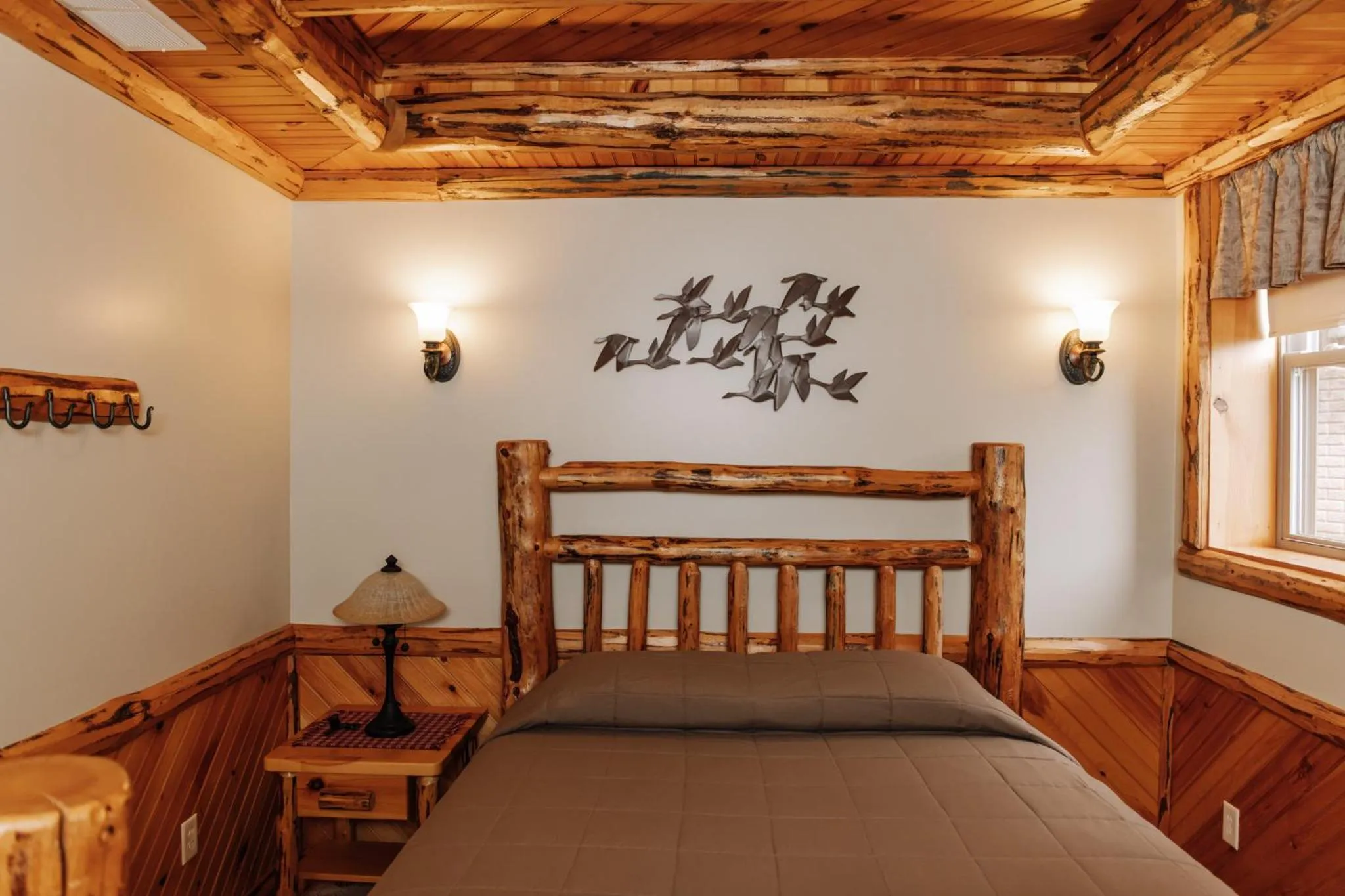 Bed in Sojourner's Lodge & Log Cabin Suites