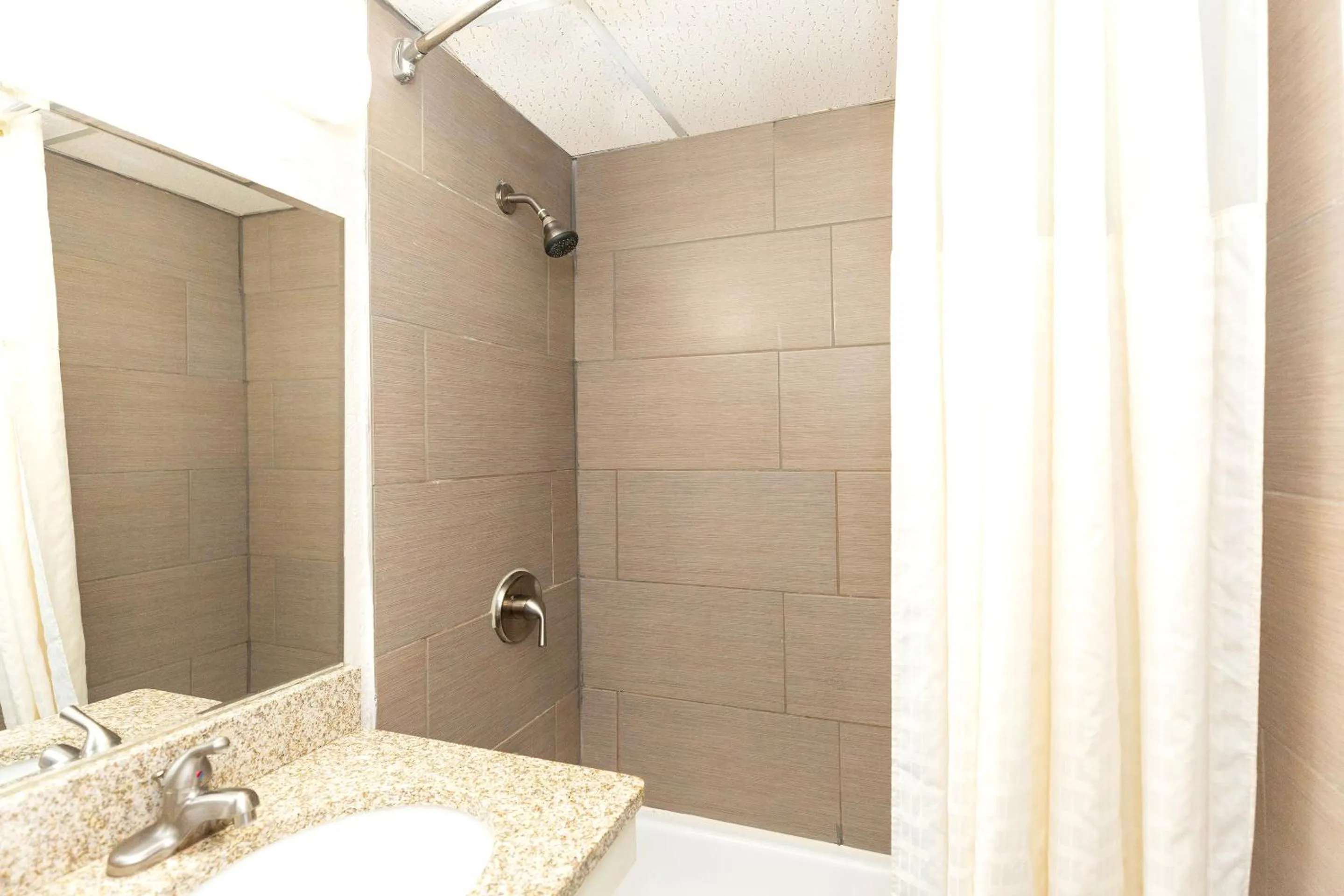 Shower in Coratel Inn & Suites by Jasper Mankato