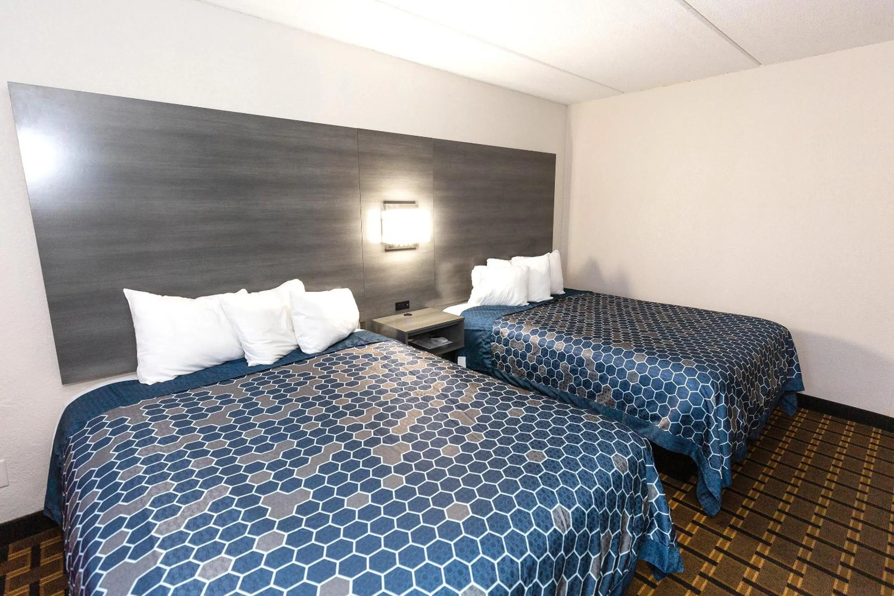 Bed in Coratel Inn & Suites by Jasper Mankato
