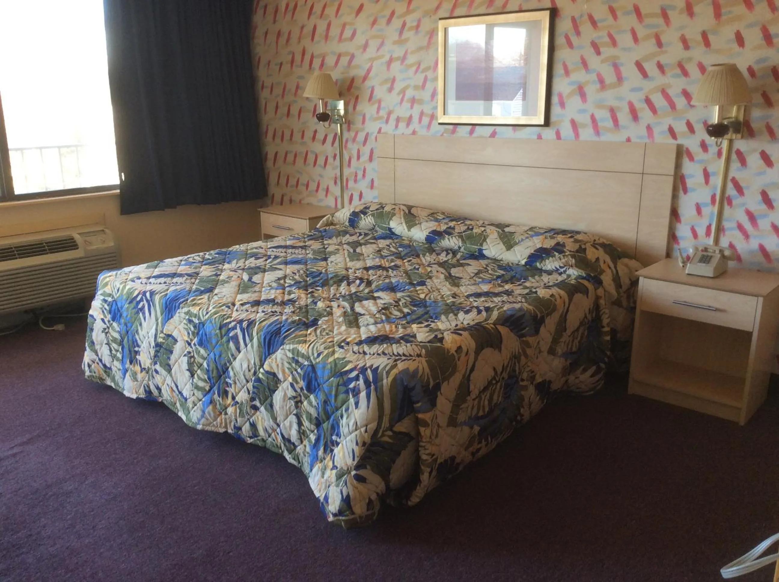 Bed in MacThrift Motor Inn