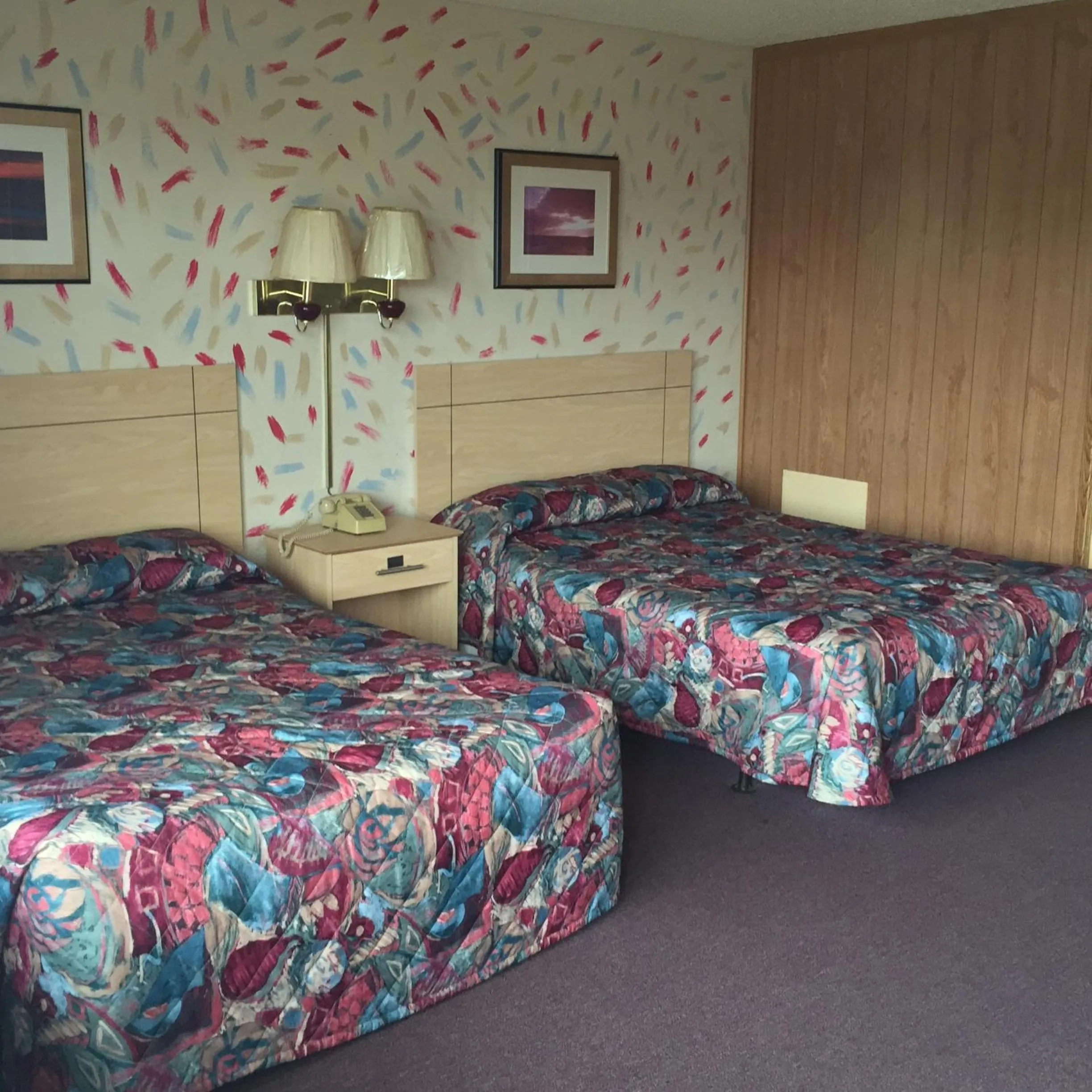 Bed in MacThrift Motor Inn