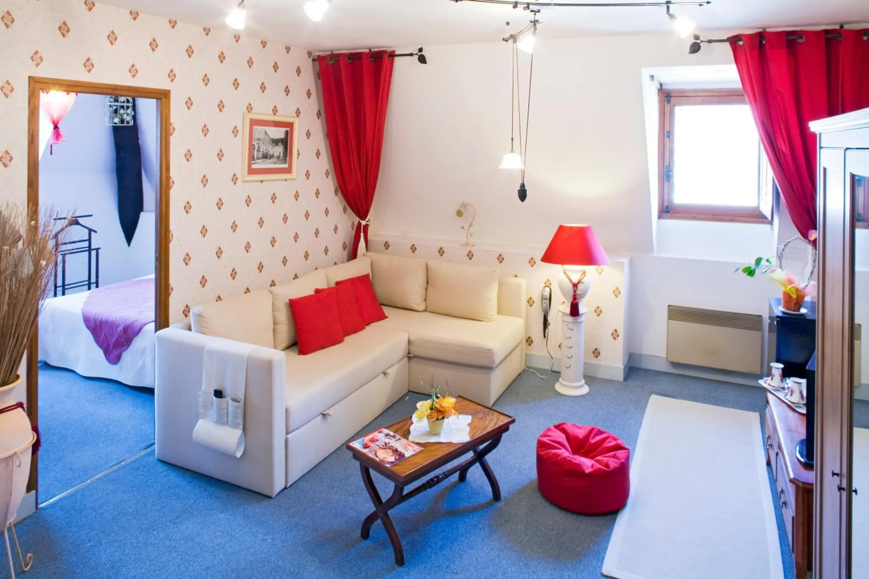 Living room, Bed in Logis Hôtel Restaurant Le Puits Doré Living room, Bed in Logis Hôtel Restaurant Le Puits Doré