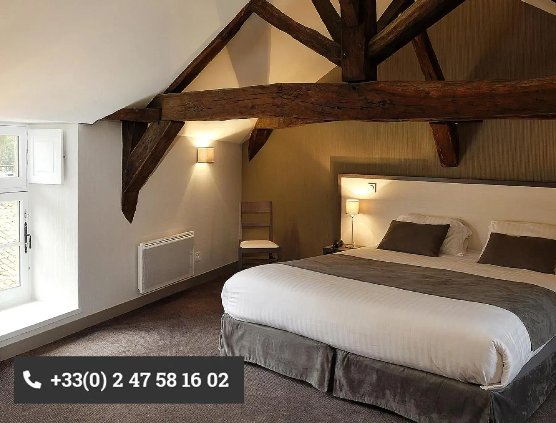 Property building, Bed in Logis Hôtel Restaurant Le Puits Doré Property building, Bed in Logis Hôtel Restaurant Le Puits Doré