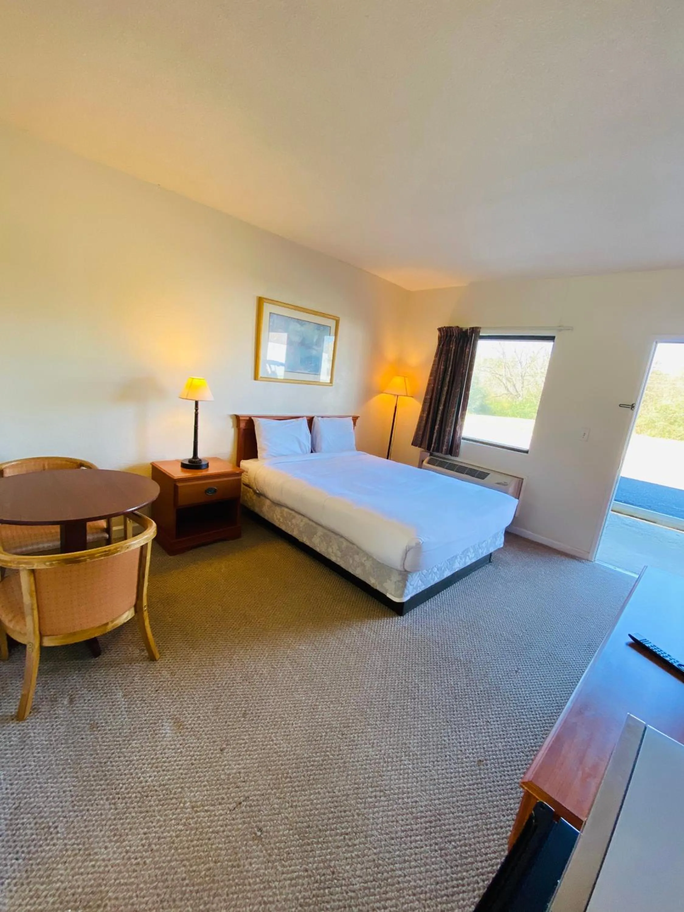 Bed in Traveler's Place Inn & Suites