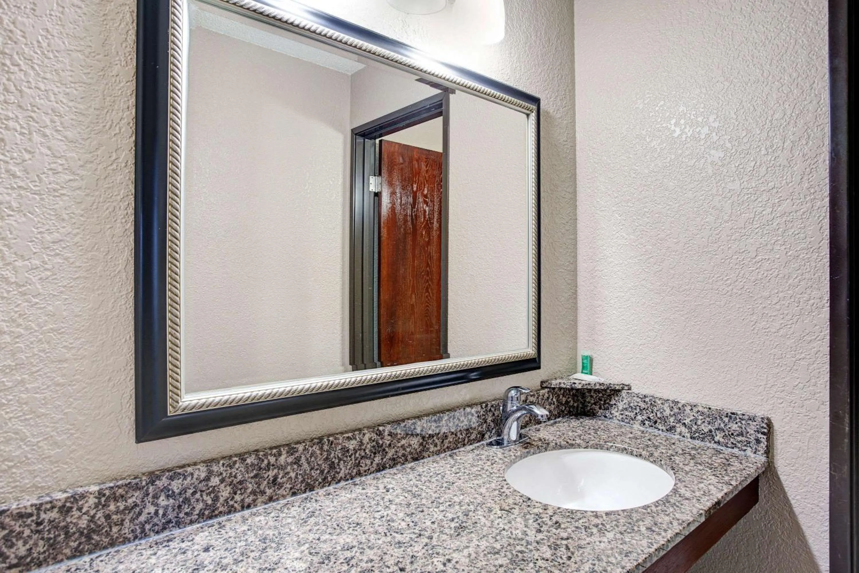 Bathroom in Super 8 by Wyndham Roseville/Detroit Area