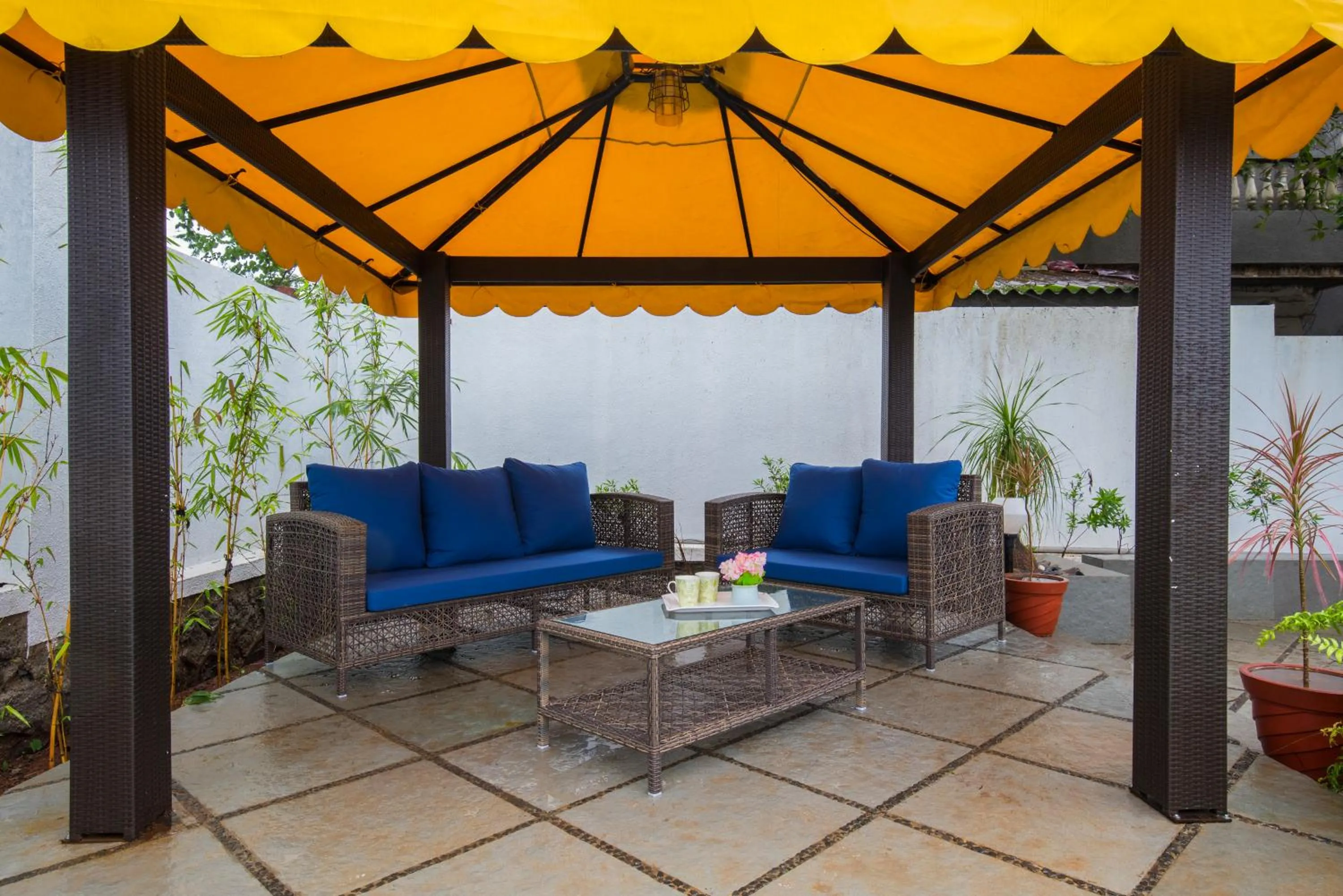 Balcony/Terrace in EL Lodge by StayVista - Pool, lawn, and a charming gazebo for your perfect getaway