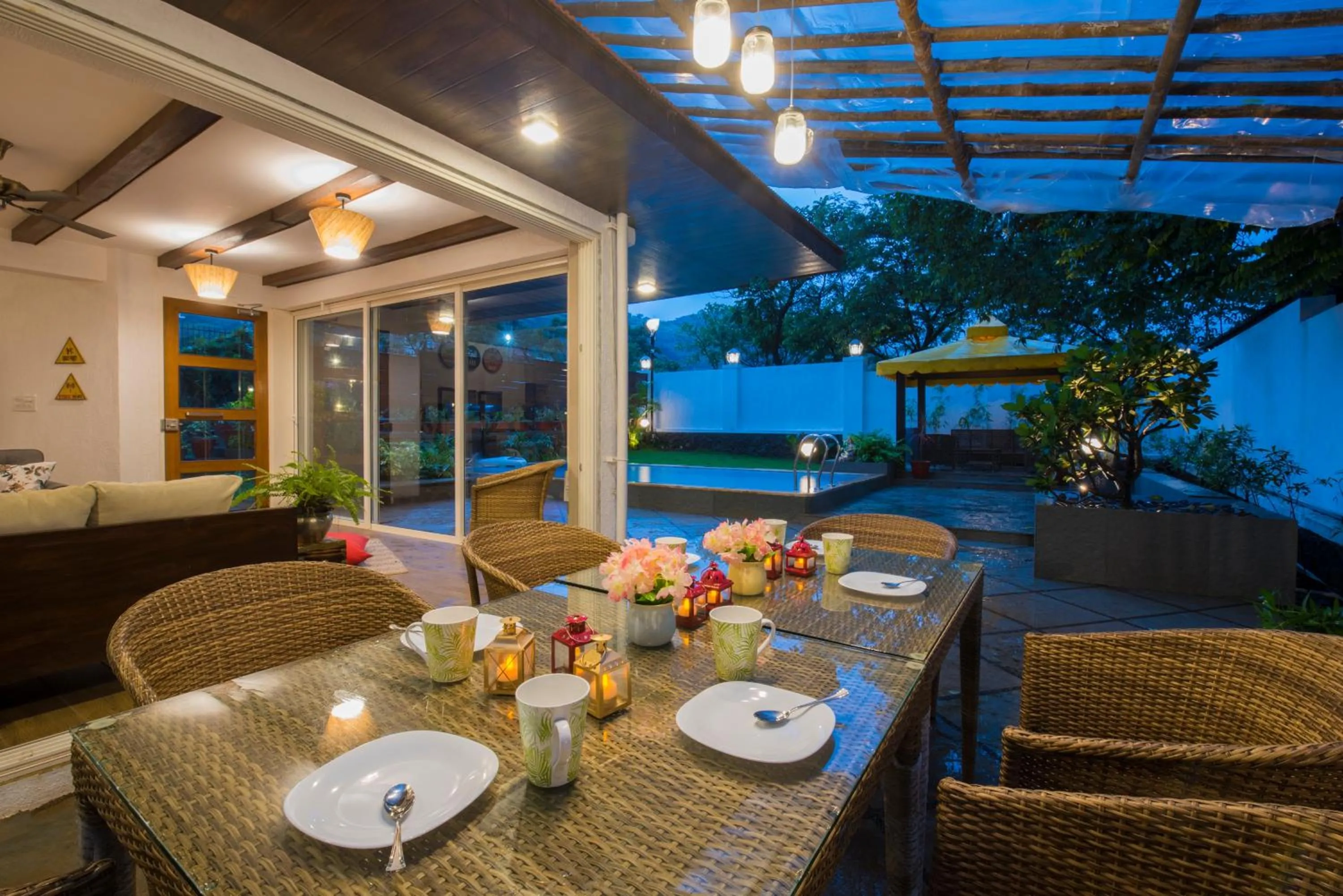 Dining area in EL Lodge by StayVista - Pool, lawn, and a charming gazebo for your perfect getaway