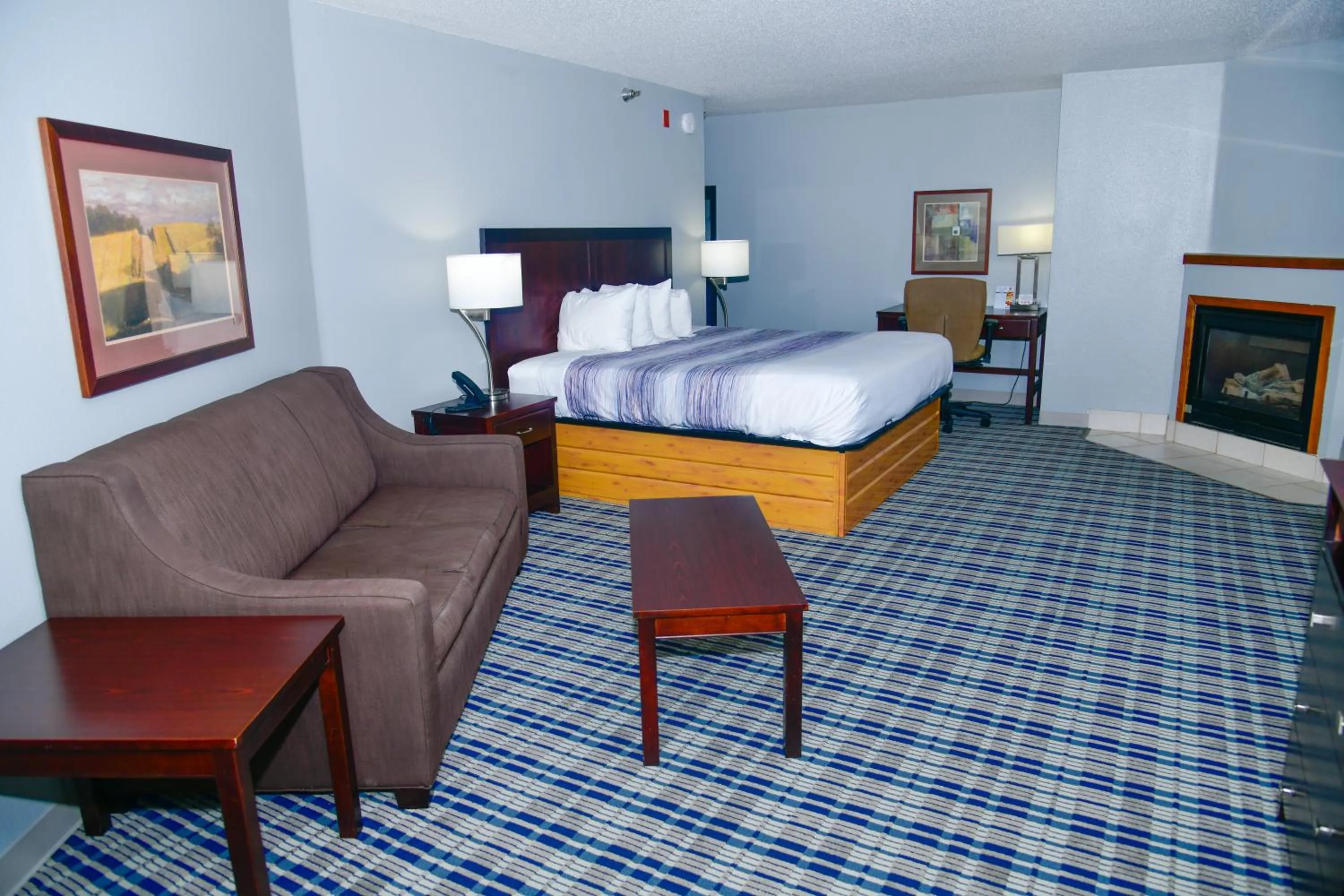 Bed in AmericInn by Wyndham Muscatine