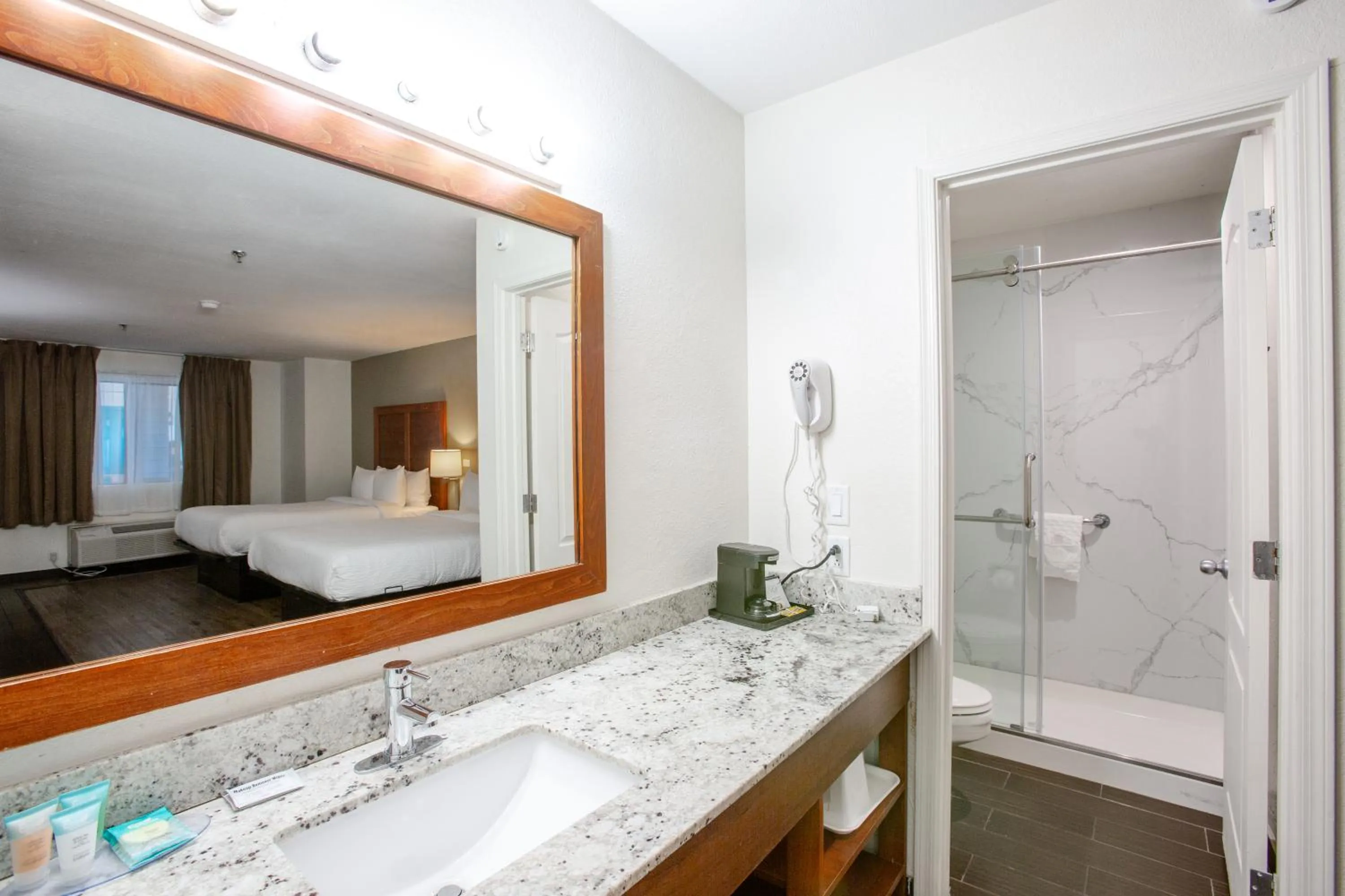 Bathroom, Bed in The Hotel Serene Glendale Peoria, Surestay Collection by Best Western