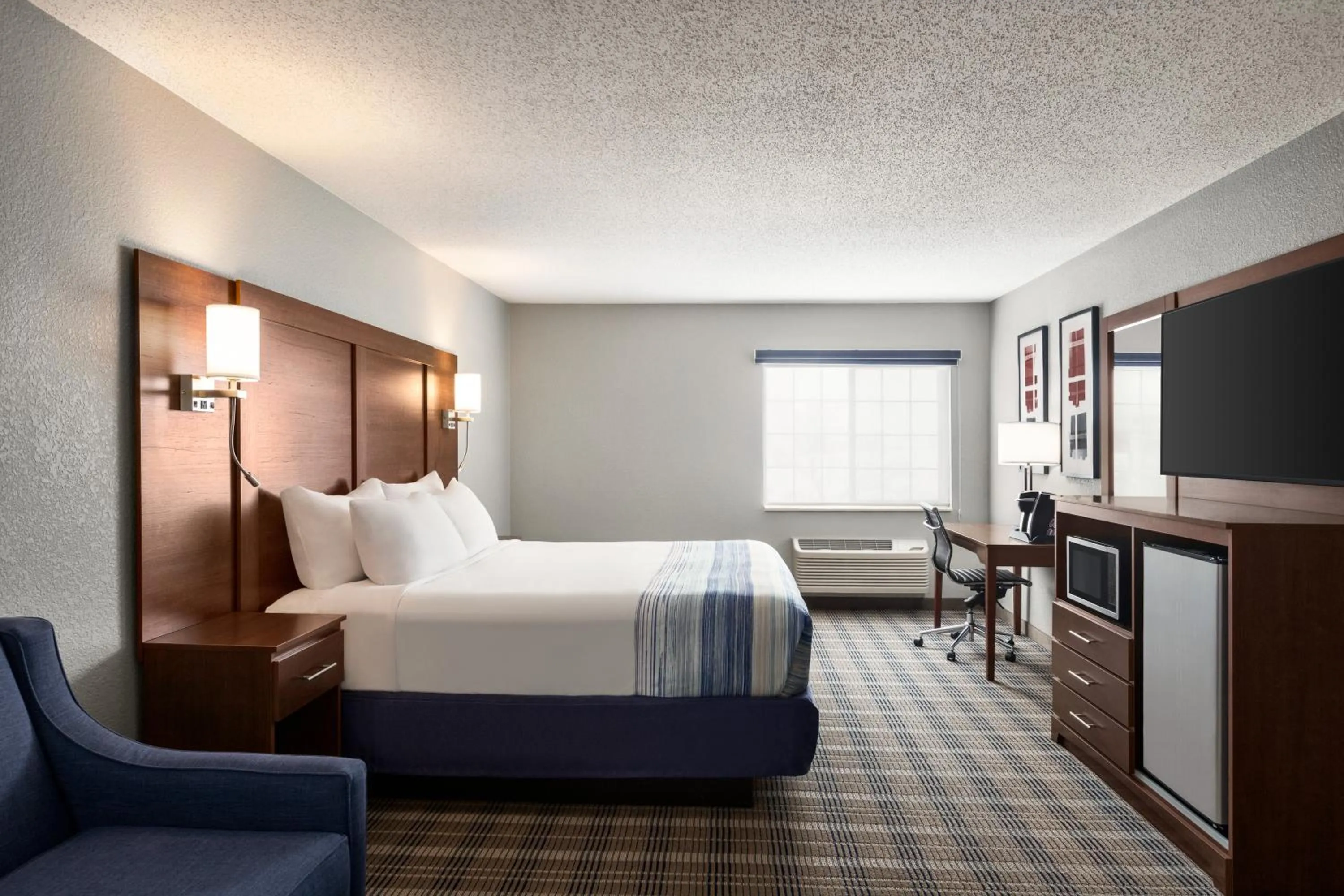 Bed in AmericInn by Wyndham Williamsburg