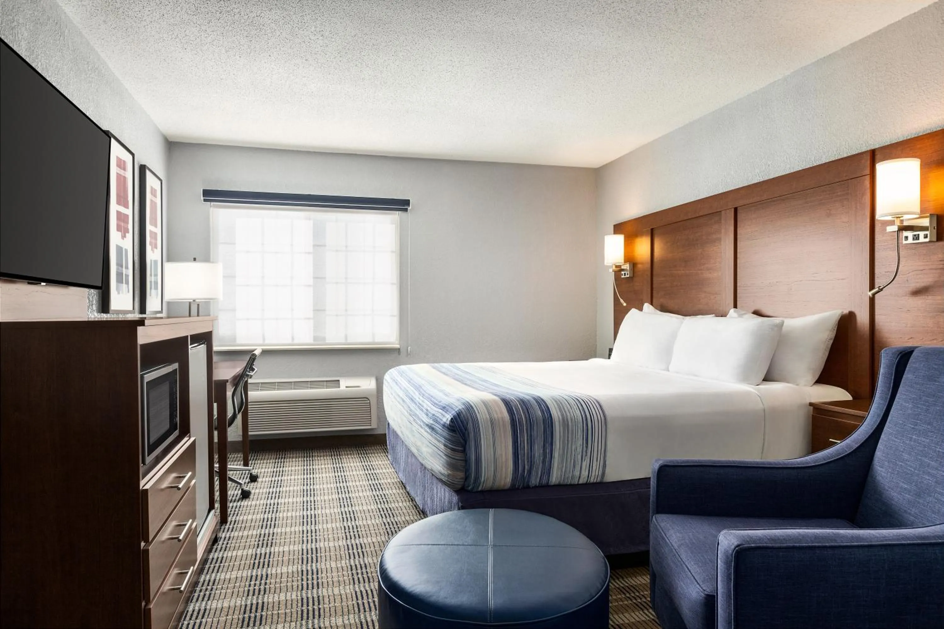 Bed in AmericInn by Wyndham Williamsburg