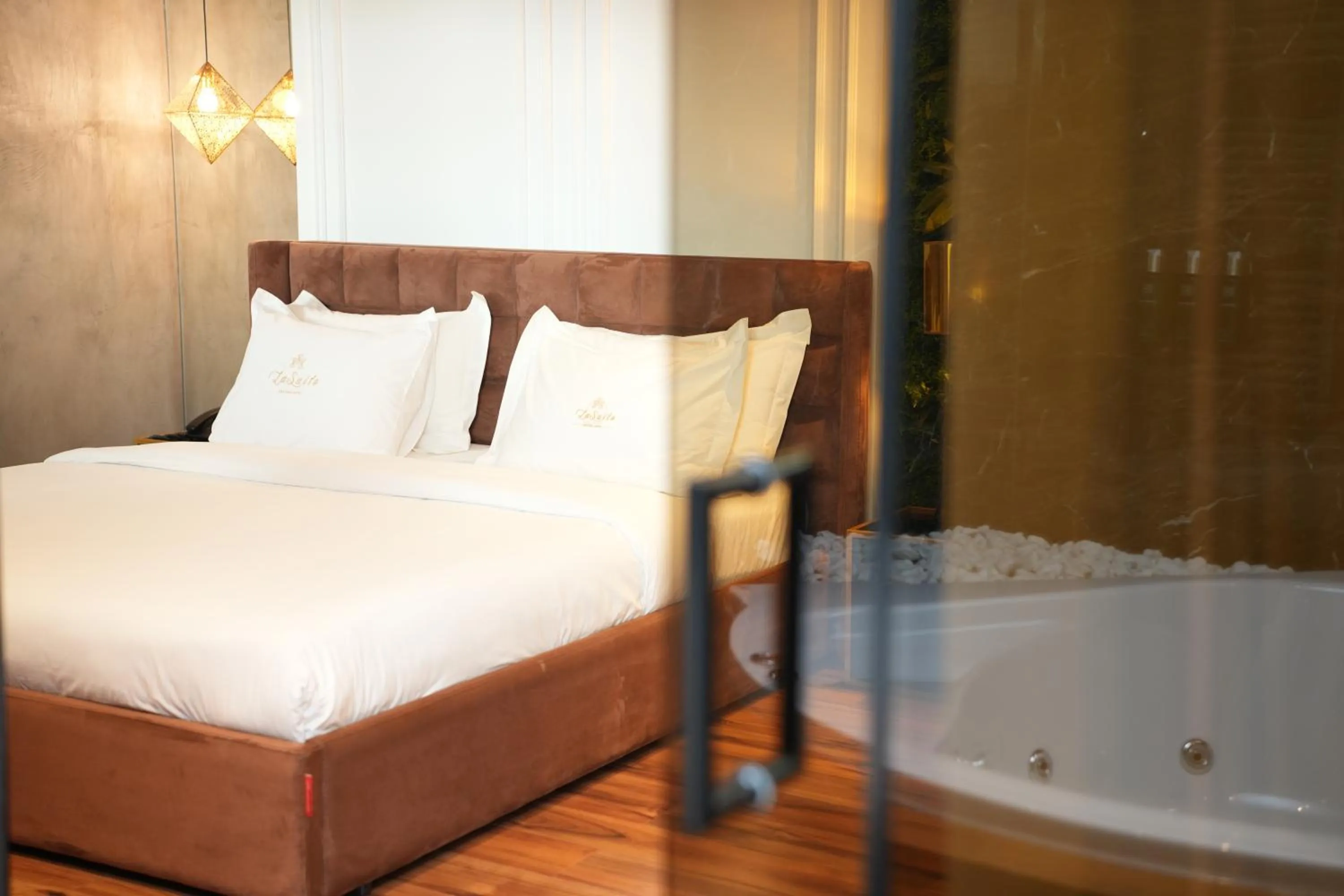 Bed in La Suite Boutique Hotel